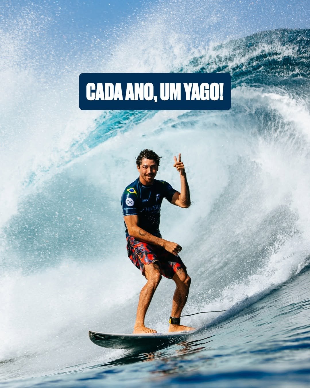 A surfer performing a maneuver on a wave while holding up a peace sign.