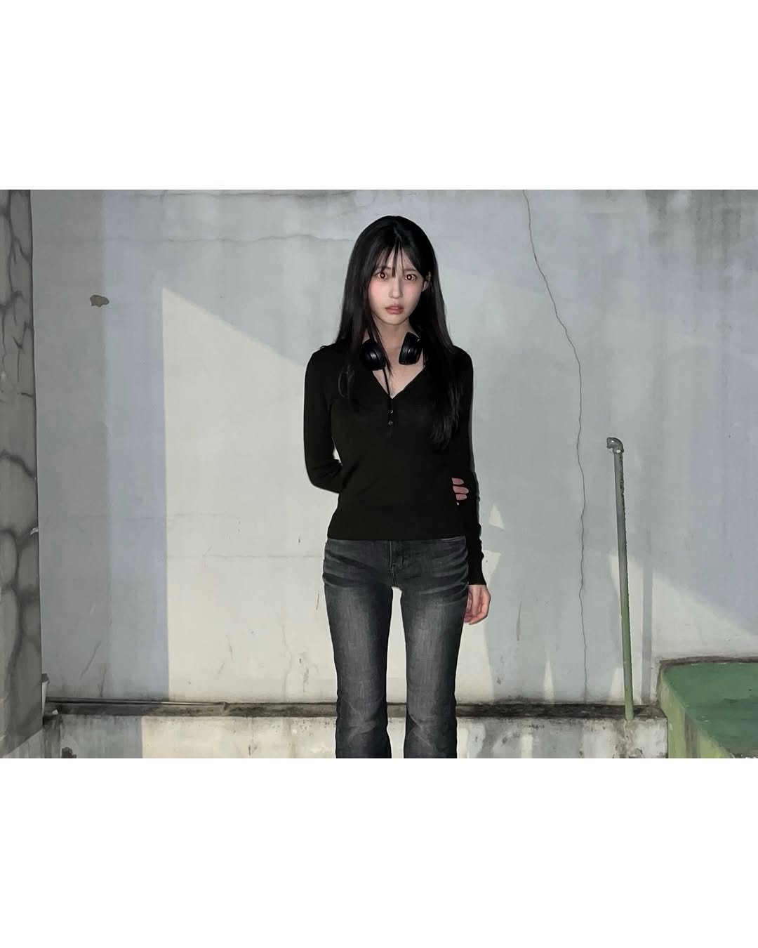 Photo shared by 이자민 on November 12, 2025 tagging @synerjyn_official. May be an image of standing, duffle coat, cigarette and text.