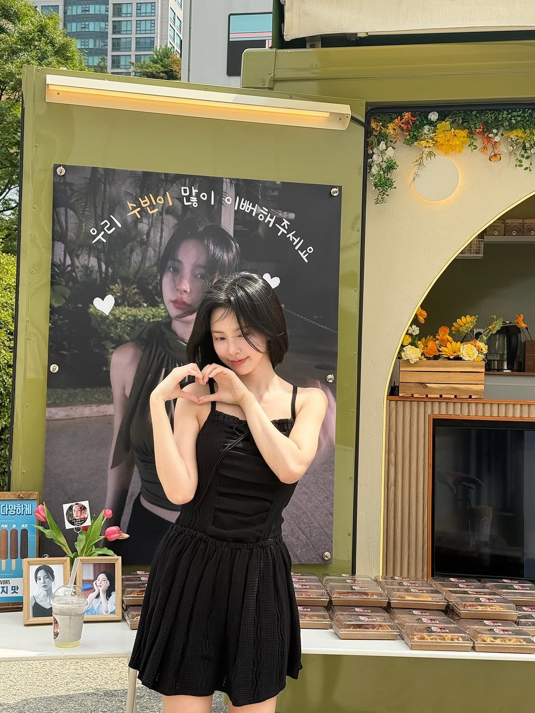 Photo by 신수현 on August 28, 2025. May be an image of 2 people, signboard, dress, poster, display case, outdoors and text.