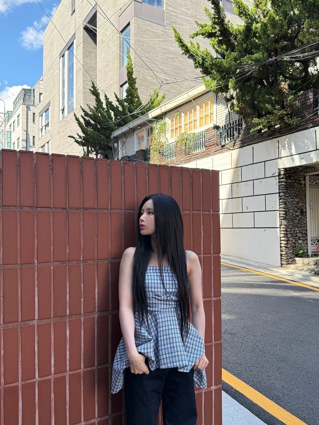 Photo by 박지원 on October 29, 2025. May be an image of overskirt, street, brick wall and text.