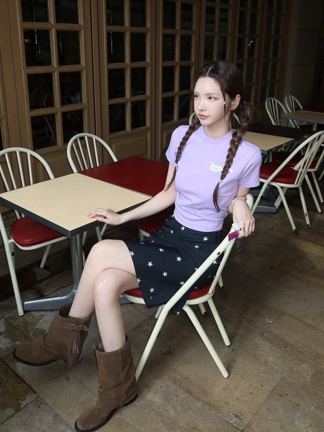 Photo by xöoos 수스 on September 19, 2025. May be an image of 1 person, braids, boots, turtleneck, skirt, top, miniskirt and text.