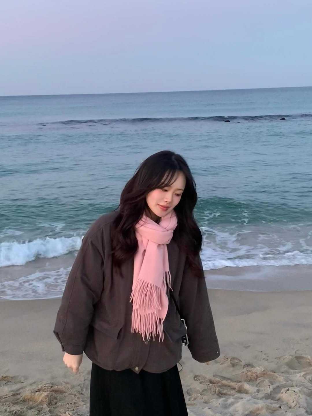 Photo by 김유진 on February 18, 2026. May be an image of duffle coat, parka, ocean, beach and text.