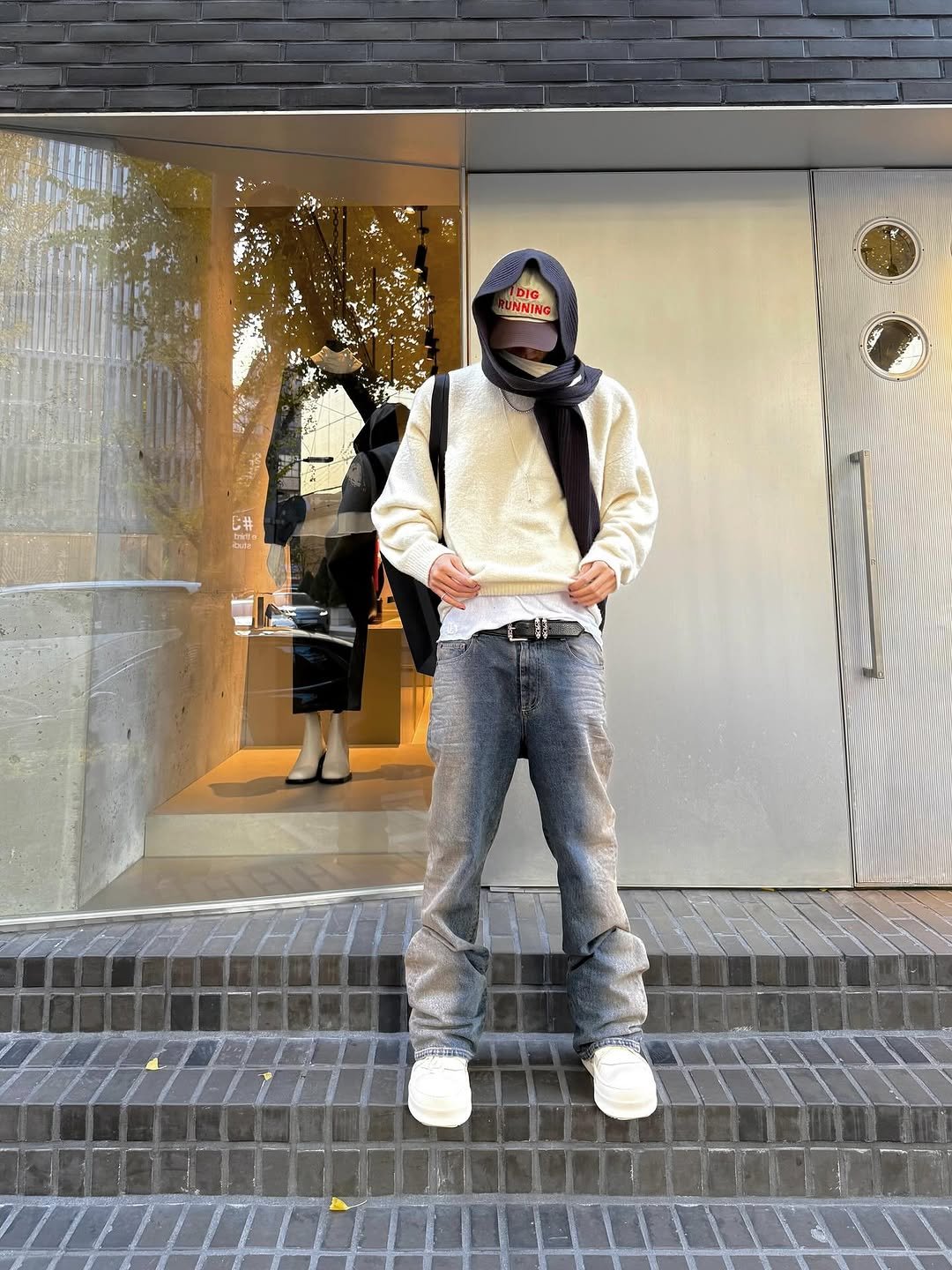 Photo by SEVENTEEN The8 on November 19, 2025. May be an image of one or more people, duffle coat, sweatpants, parka, bandanna, face mask, street and text.