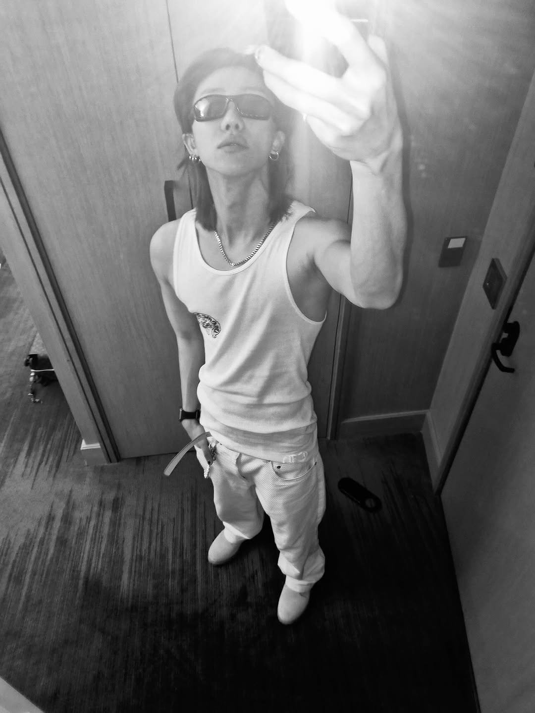 Photo by SEVENTEEN The8 on October 15, 2025. May be a black-and-white image of one or more people, biceps, hair, phone, mirror, tanktop, sweatpants and text.