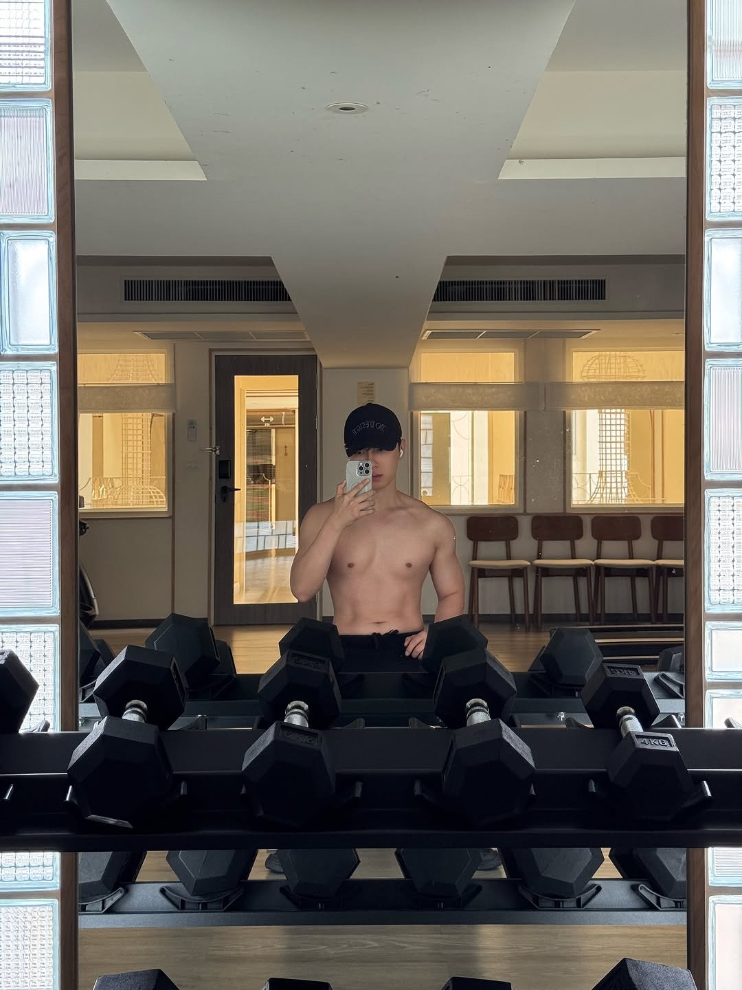 Photo by O on June 29, 2025. May be an image of 2 people, biceps, dumbbell, mirror and text.