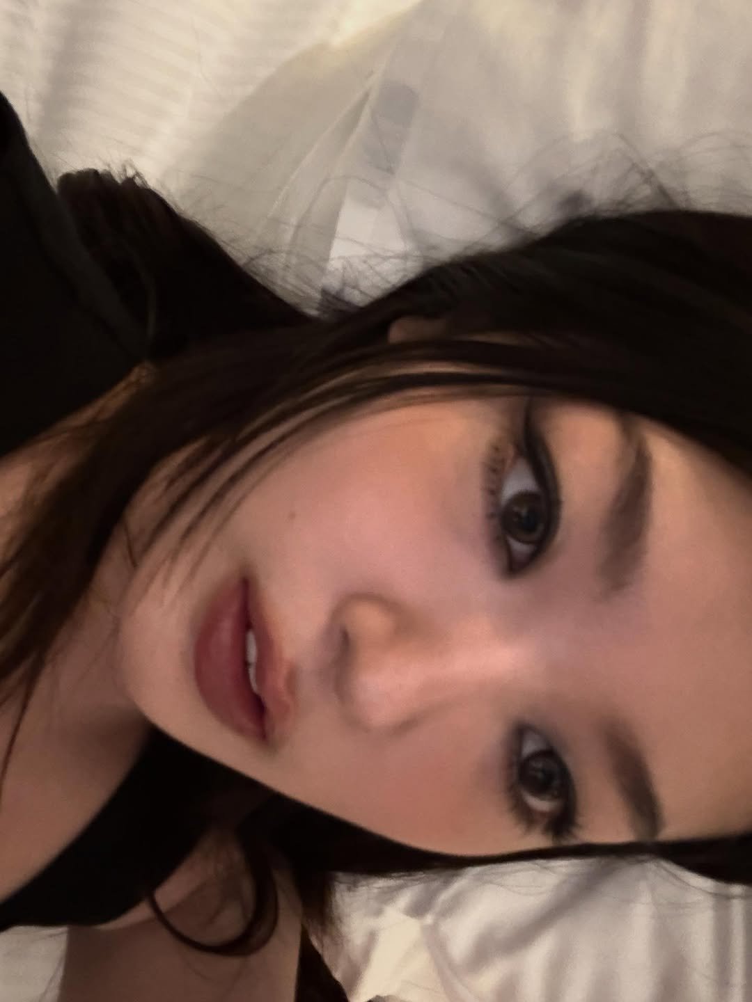 Photo by YOONCHAE JEUNG on November 10, 2025. May be a selfie of one or more people, hair, eyeliner, makeup, bed, bedroom and text.