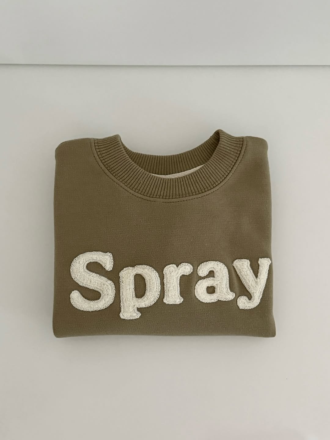 Photo shared by 윤샤샤 ◡̈ on September 29, 2025 tagging @seaspray.kr. May be an image of sweater, sweatshirt and text that says 'Spray'.
