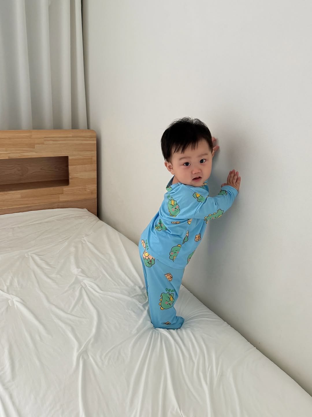 Photo shared by 윤샤샤 ◡̈ on November 09, 2025 tagging @1pro_official_. May be an image of baby, standing, sleepwear, bed, mattress, bedroom and text.