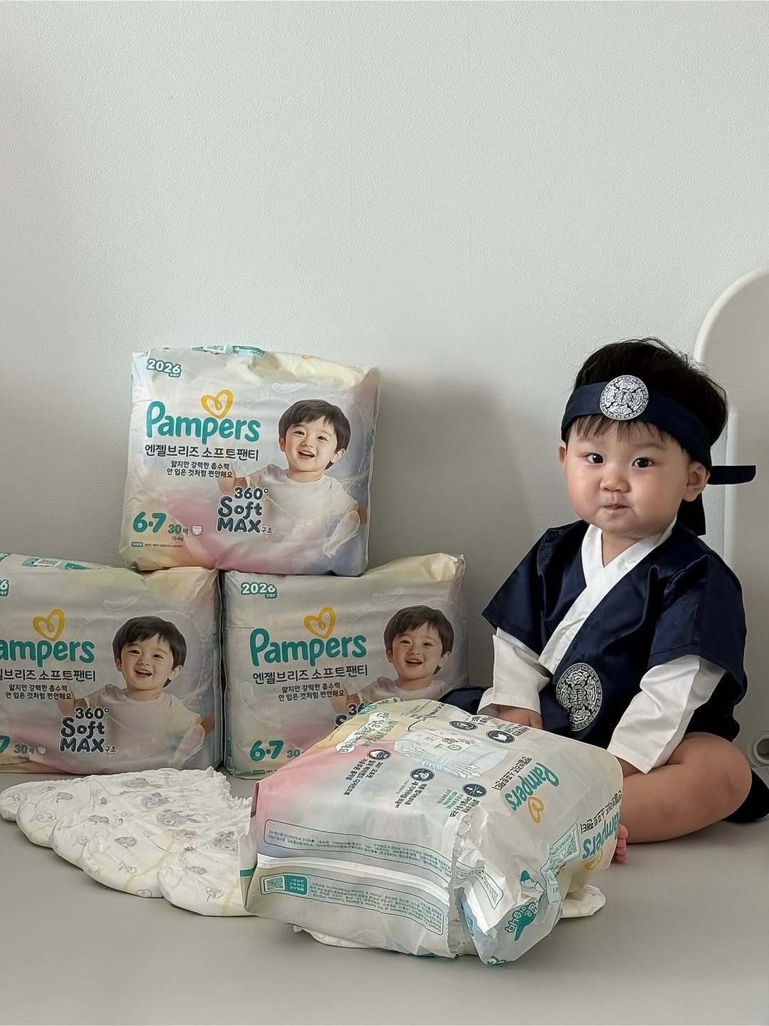 Photo shared by 윤샤샤 on February 12, 2026 tagging @pamperskr. May be an image of baby, diaper, baby bed, baby shoes and text.