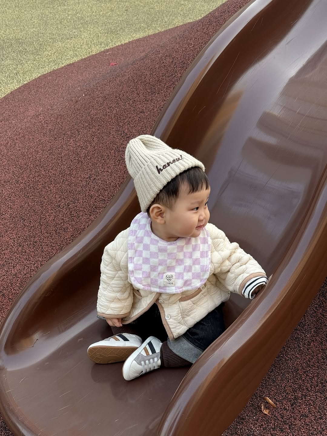 Photo shared by 윤샤샤 ◡̈ on December 20, 2025 tagging @coteme_official. May be an image of baby, slide, baby shoes, park and text.