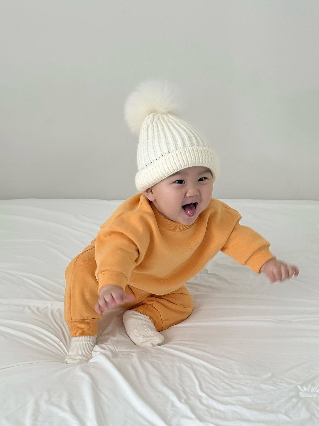 Photo shared by 윤샤샤 ◡̈ on November 03, 2025 tagging @machere_official. May be an image of baby, sleepwear, hat, knit and text.