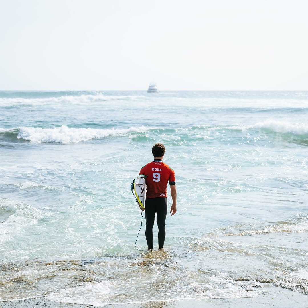 Photo by yAGO doRA on April 19, 2026. May be an image of surfboard, wetsuit, ocean, water, beach and text.