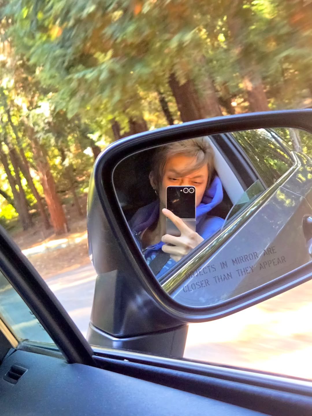 Photo by YEONJUN on September 22, 2025. May be an image of 1 person, rearview mirror, car, mirror, road and text.
