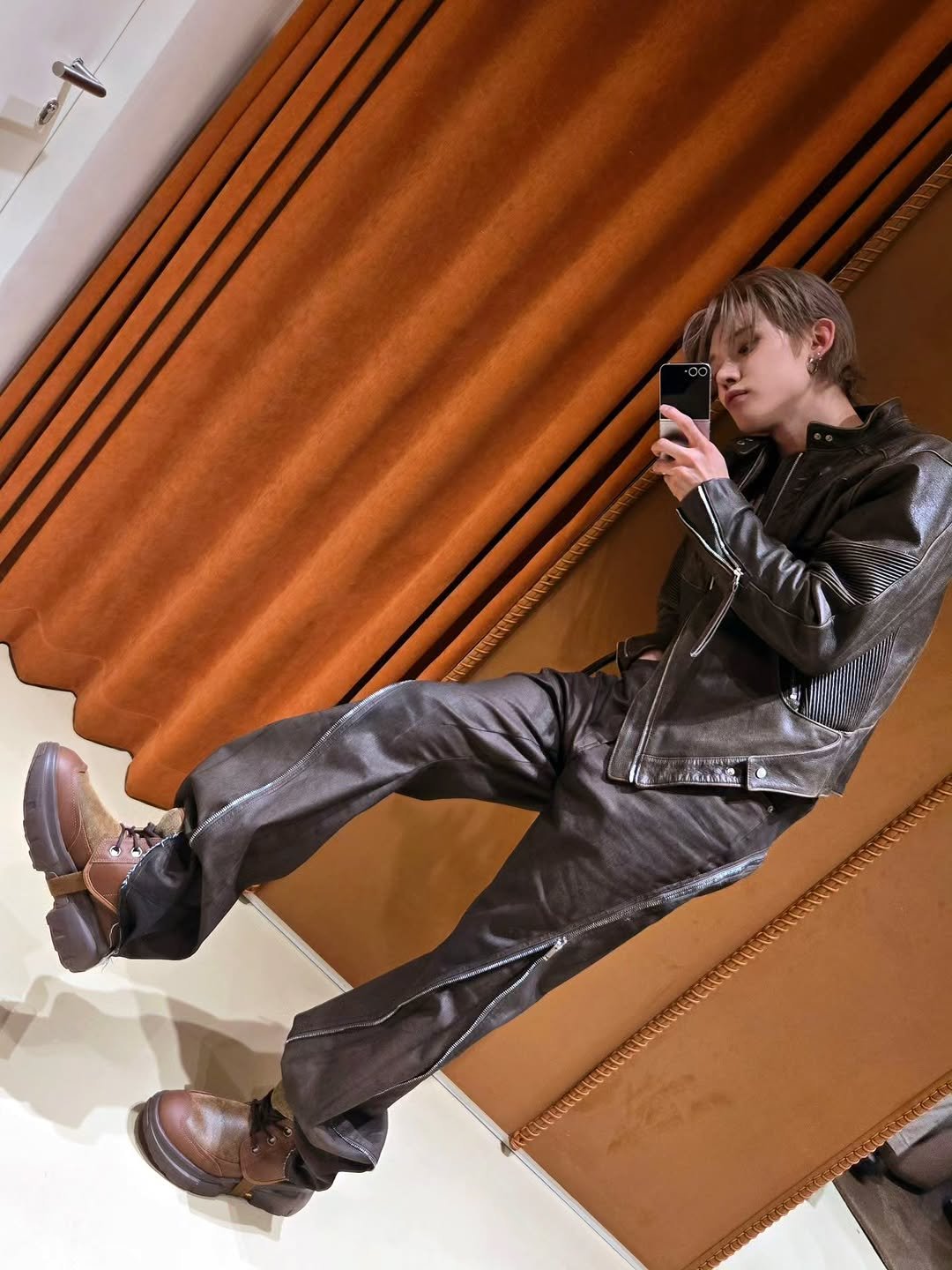 Photo shared by YEONJUN on October 31, 2025 tagging @ugg_korea. May be an image of wingtip shoes, duffle coat, overcoat, suit, blazer and text.