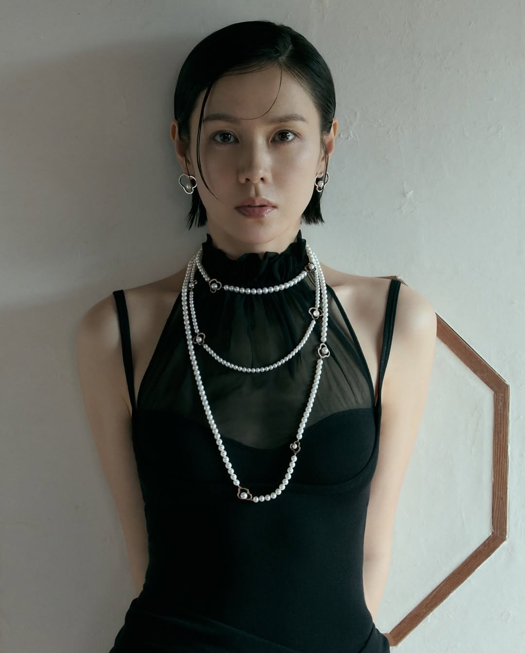 Photo shared by TASAKI on March 08, 2026 tagging @yejinhand. May be an image of one or more people, makeup, halter top and text.