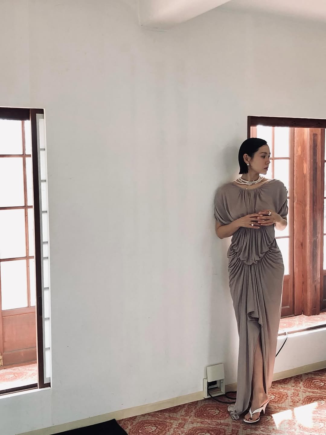 Photo by 손예진 on March 07, 2026. May be an image of sleepwear, dress, sarong and text.