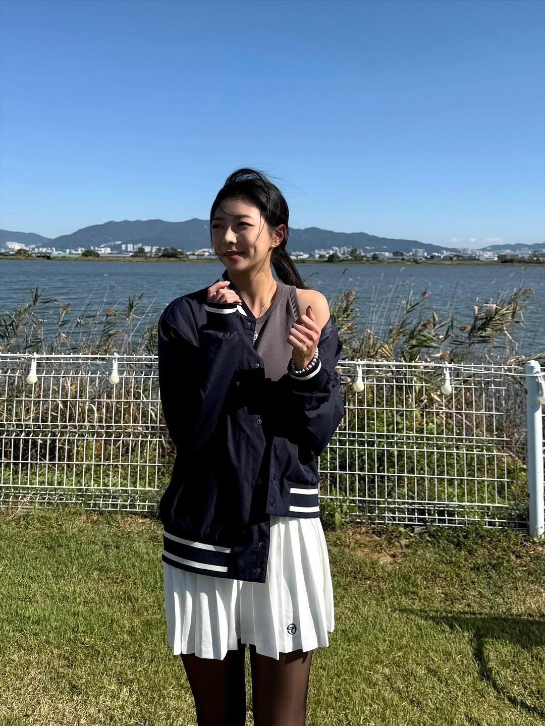 Photo shared by 김예은 on October 27, 2025 tagging @sergiotacchini, and @sergiotacchini_kr. May be an image of miniskirt, parka, outdoors and text.