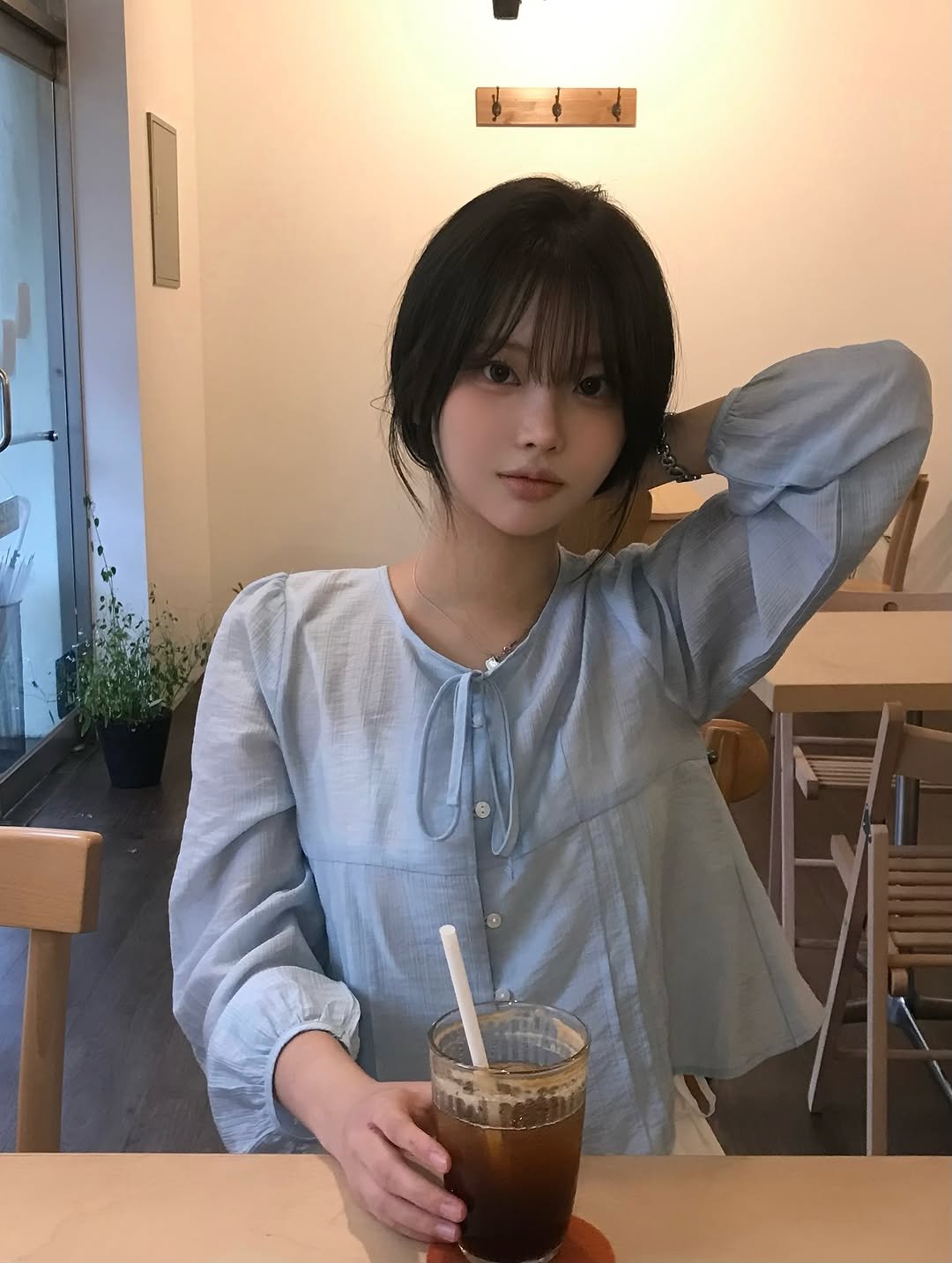 Photo shared by 연 on September 10, 2025 tagging @dear.inee. May be an image of 1 person, hair, coffee cup, cornflower and text.