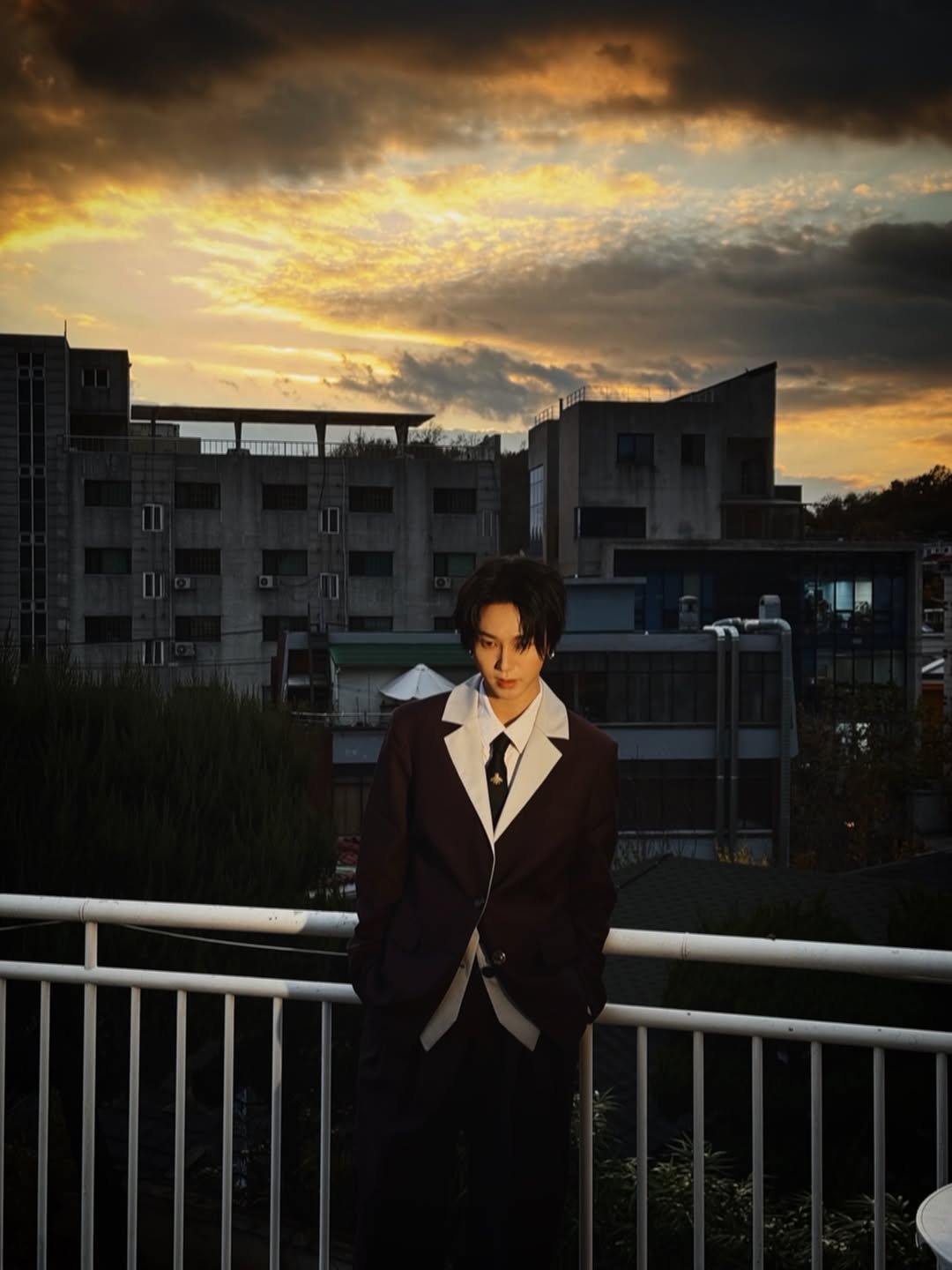 Photo shared by Yesung on December 17, 2025 tagging @yesung_smtown. May be an image of overcoat, suit, dinner jacket, blazer, cloud, twilight and text.