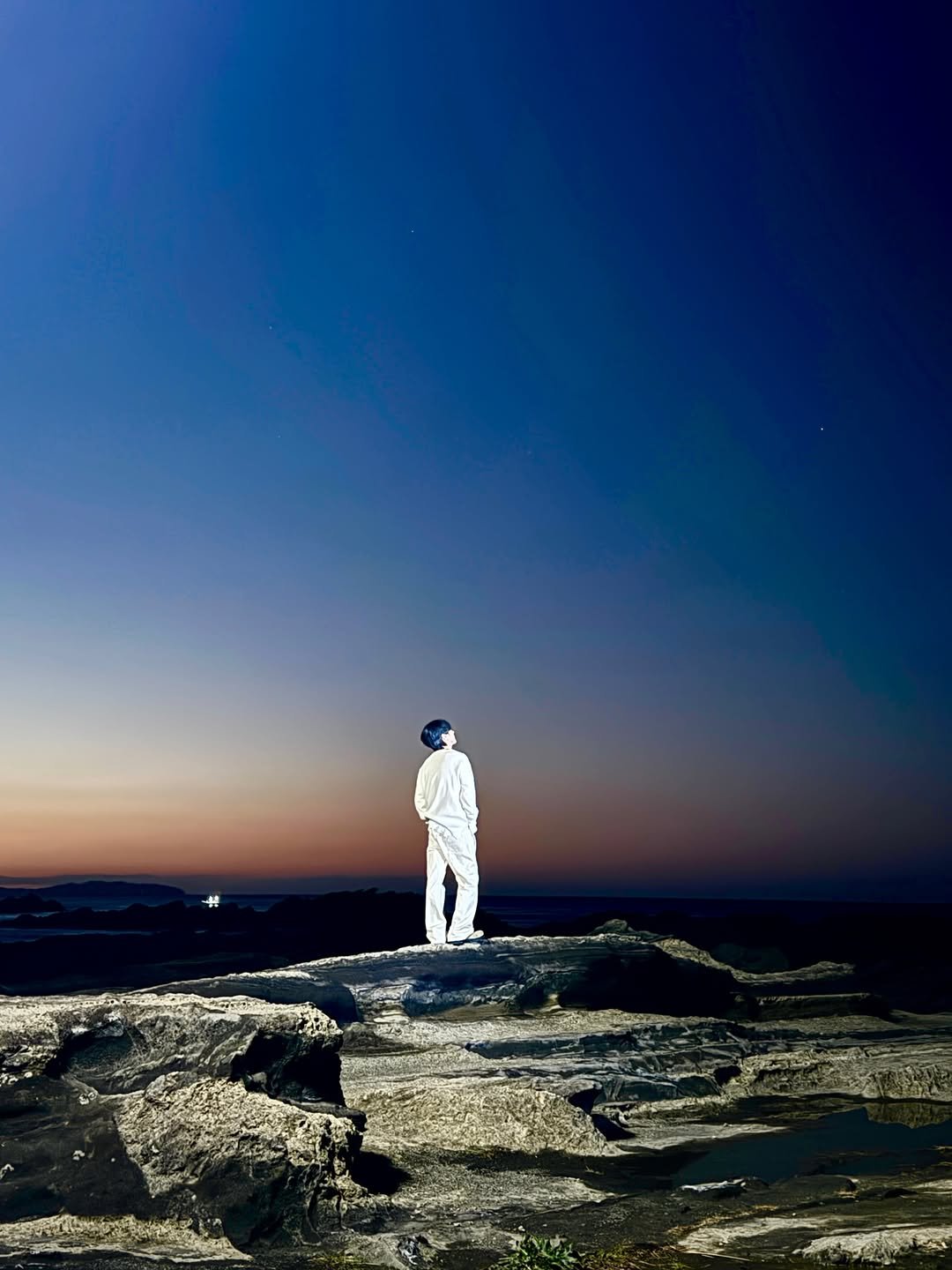 Photo shared by Yesung on April 25, 2026 tagging @yesung_jp_official, and @yesung_smtown. May be an image of standing, twilight, horizon and text.