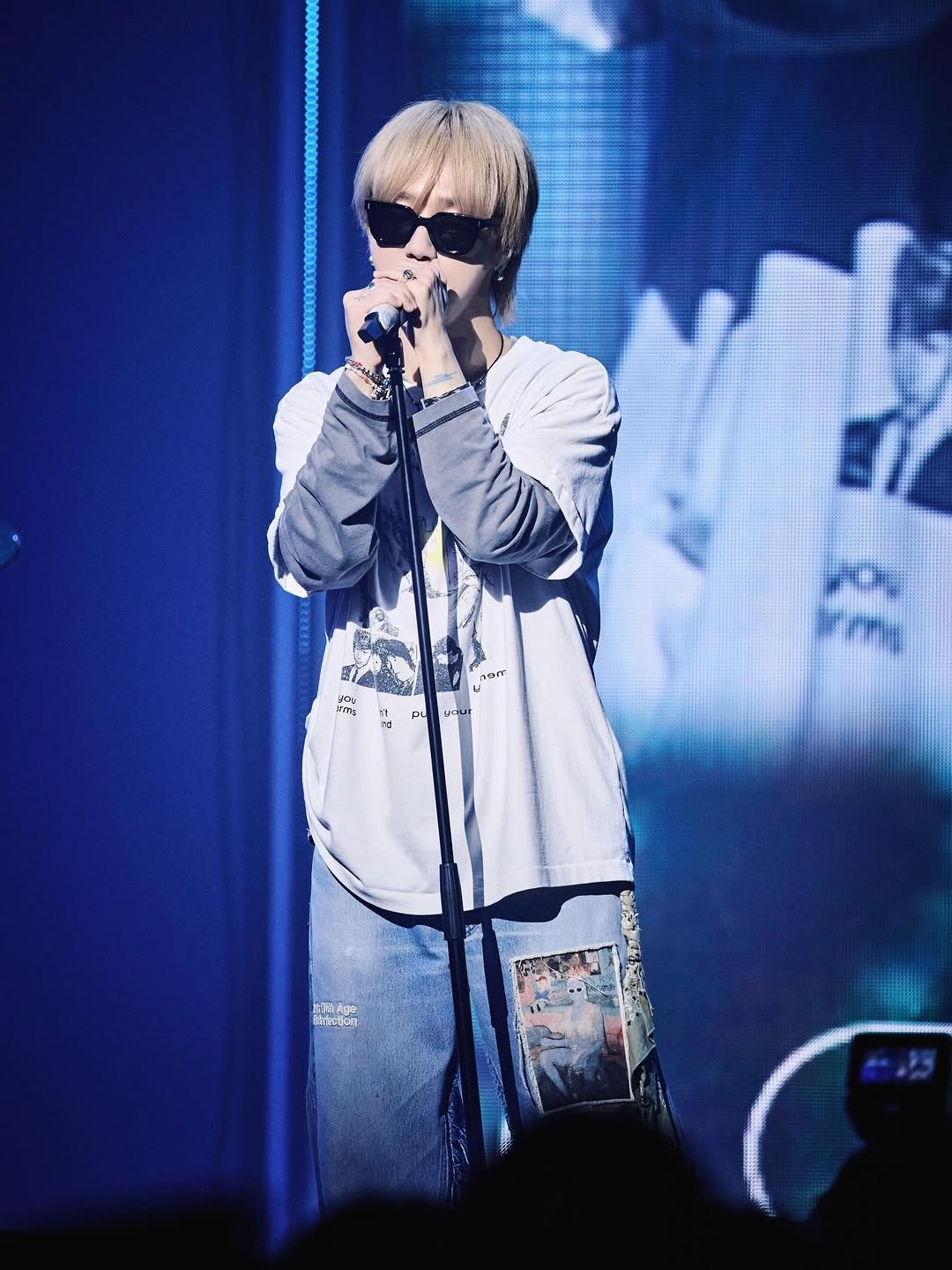 Photo shared by YESUNG_JP_OFFICIAL on February 27, 2026 tagging @yesung1106, and @yesung_smtown. May be an image of one or more people, bangs, microphone, top, concert and text.