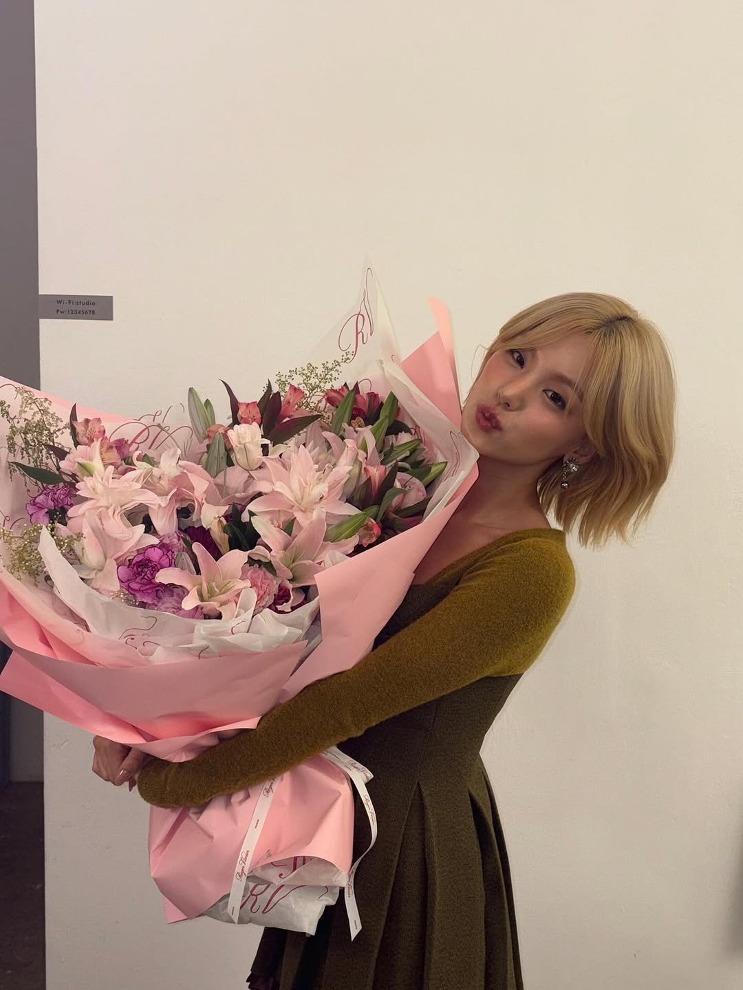 Photo shared by YEJI on September 25, 2025 tagging @rogervivier. May be an image of 1 person, baby's-breath, rose and text.