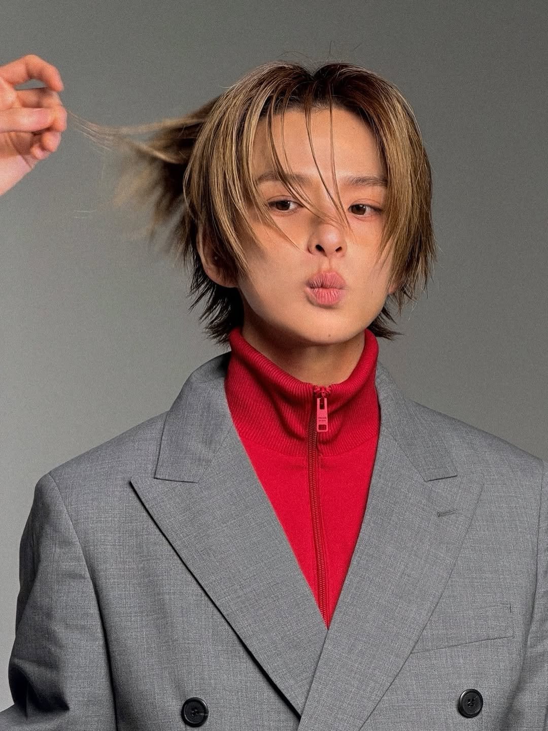 Photo by TREASURE (트레저) on April 24, 2026. May be an image of one or more people, bangs, makeup, duffle coat, top, turtleneck, bolo tie and text.