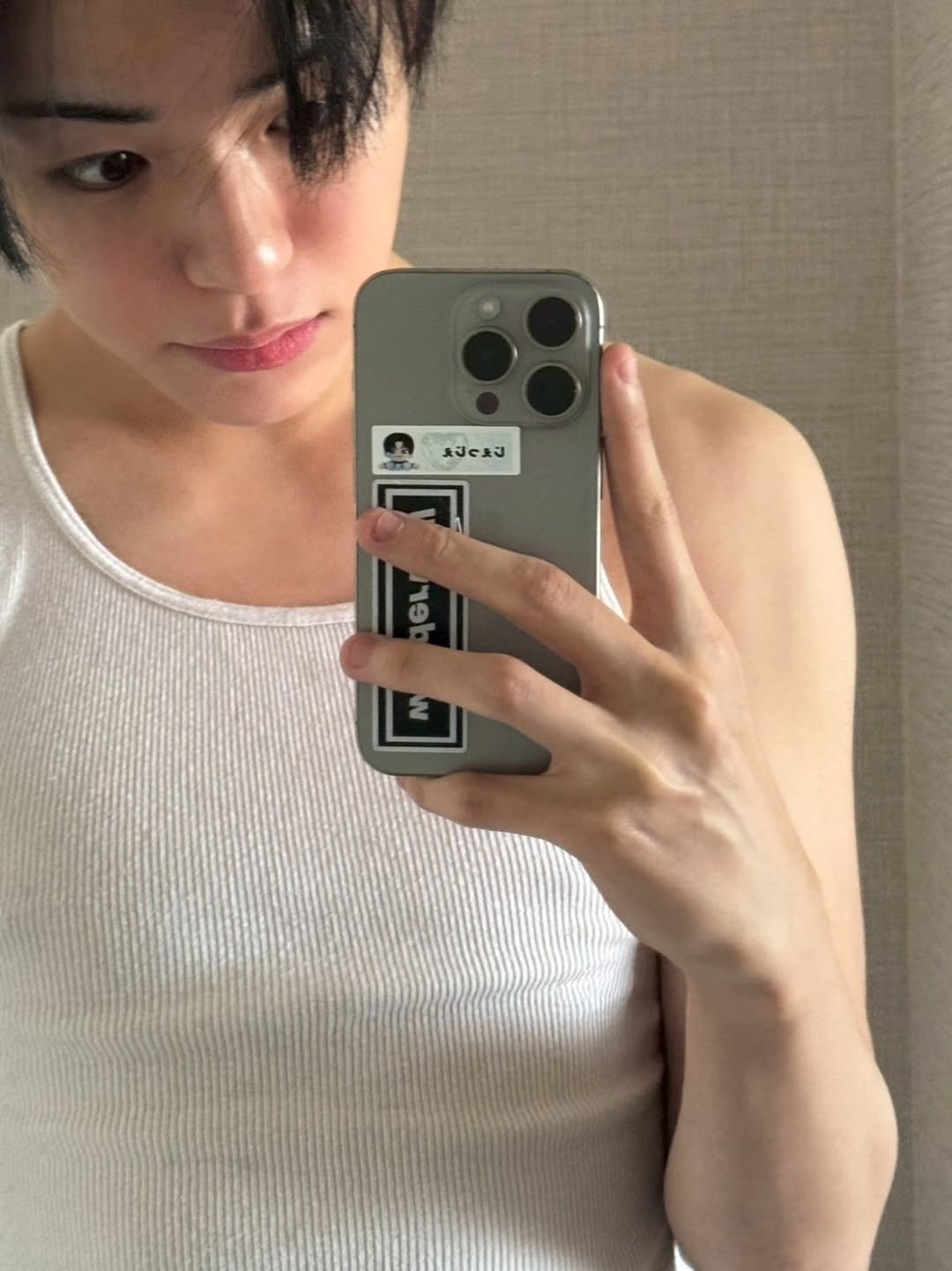 Photo by TREASURE (트레저) on January 13, 2026. May be a selfie of one or more people, hair, phone, top, mirror, tanktop and text.