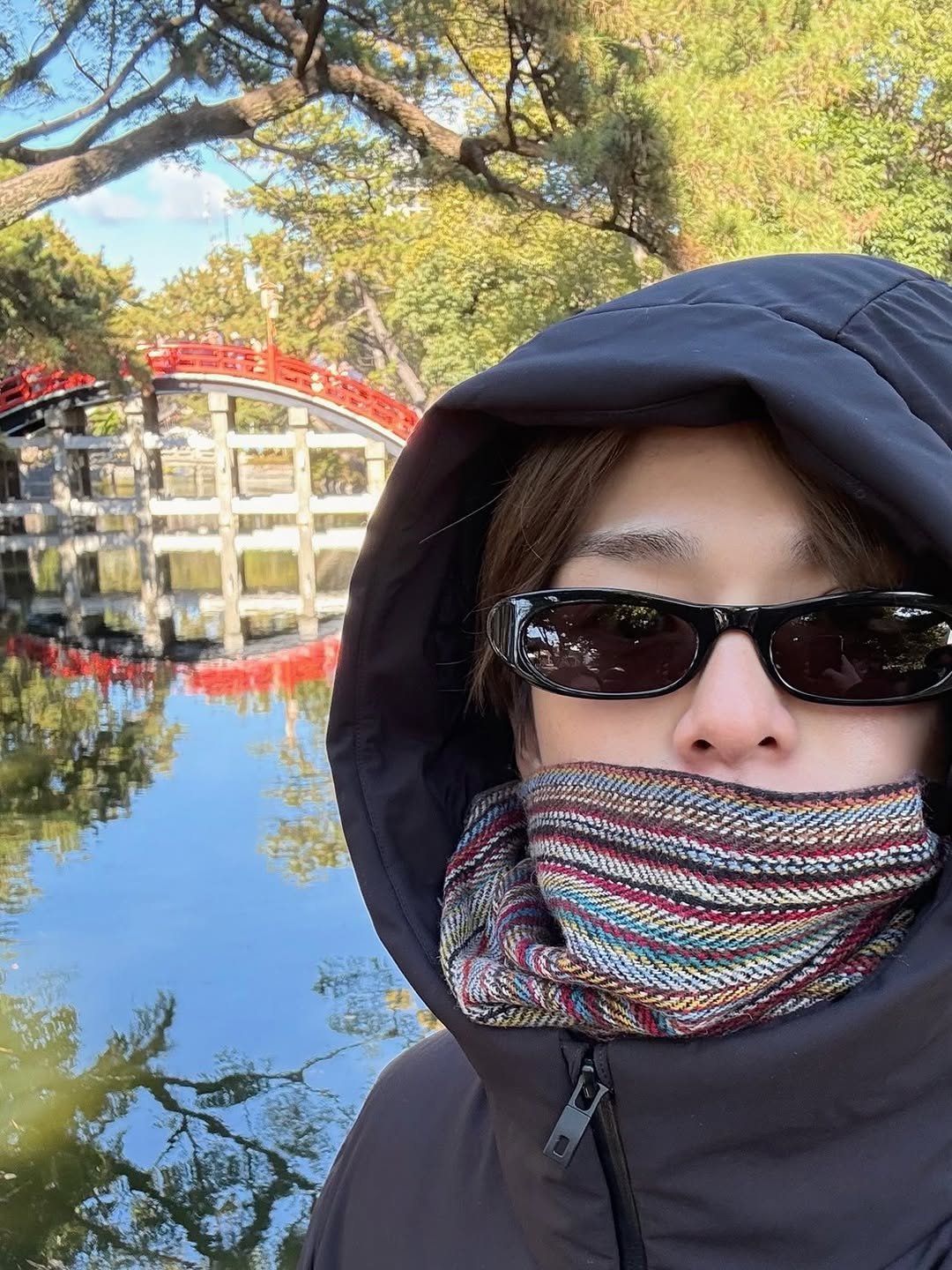 Photo by TREASURE (트레저) on January 15, 2026. May be an image of duffle coat, face mask, parka, park and text.