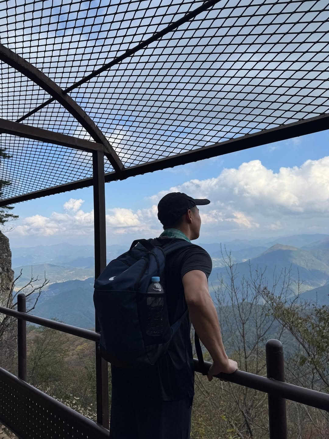 Photo shared by 요가지몽 on October 28, 2025 tagging @nikeseoul. May be an image of fire tower, mountain, suspension bridge and text.