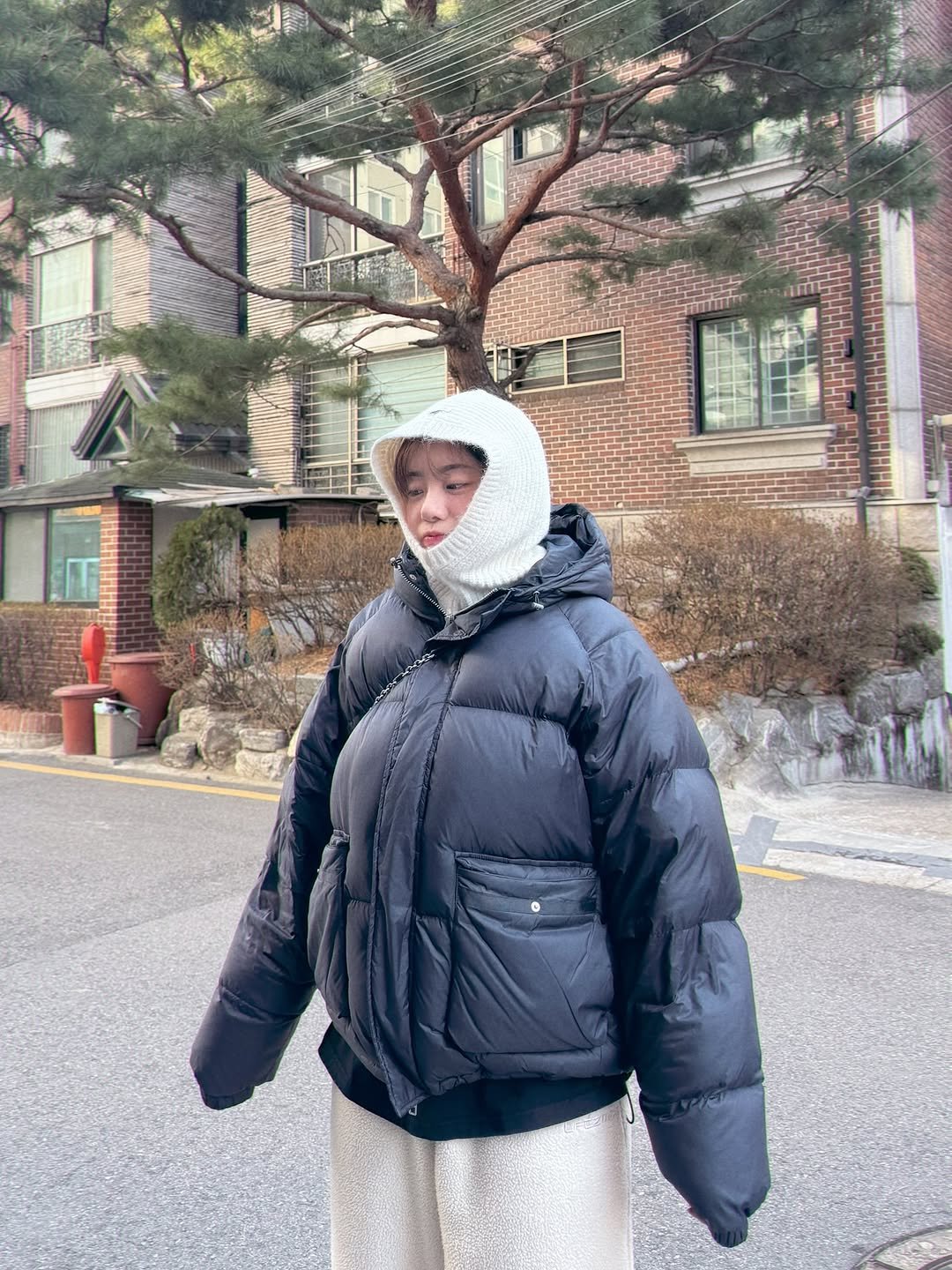 Photo shared by 💎H💎 on January 11, 2026 tagging @official.dhyani. May be an image of duffle coat, overcoat, goosedown coat, raincoat, snowsuit, parka, face mask, jacket, cloak, outdoors and text.