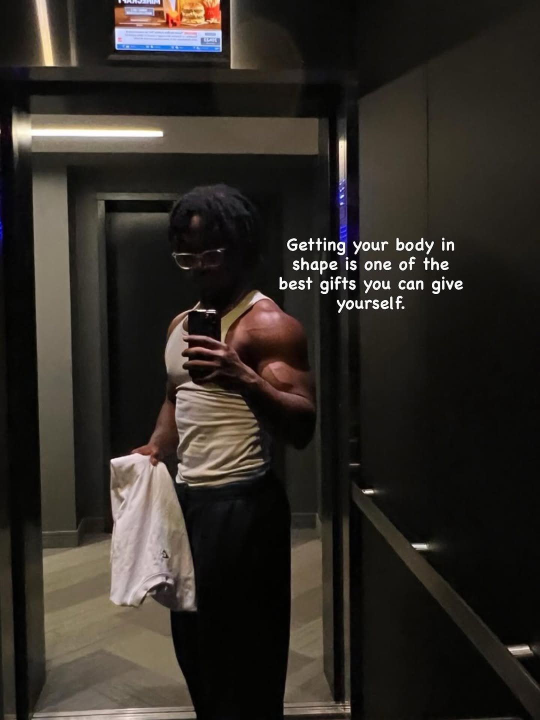 Photo by Jeremy koko on December 16, 2025. May be an image of one or more people, biceps, sweatpants and text that says 'A nM T pο LORE - Getting your body in shape is one of the best gifts you can give yourself.'.
