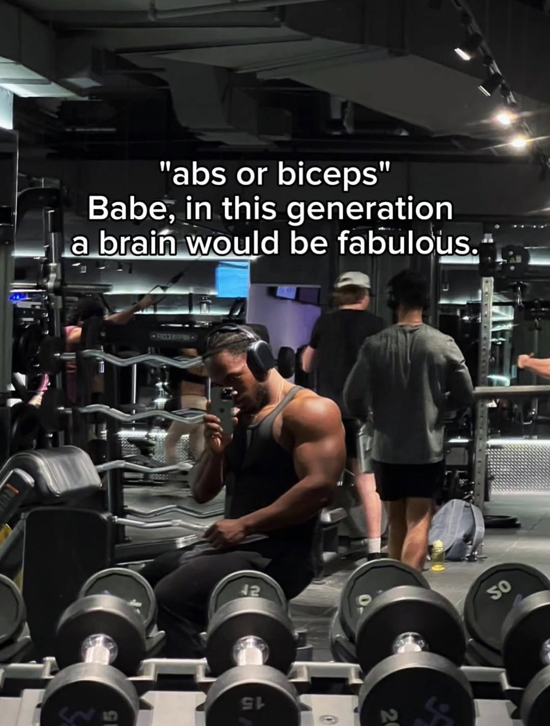 Photo by Jeremy koko on January 22, 2026. May be an image of one or more people, biceps, people bodybuilding, dumbbell and text that says '"abs or biceps" or Babe, in this generation a brain would be fabulous. 50'.