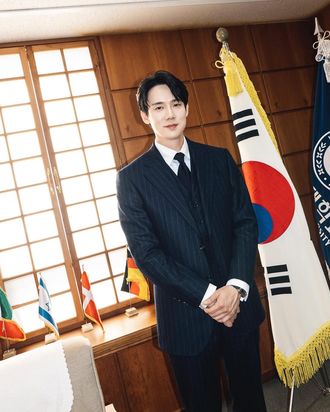 Photo by 유연석 on October 27, 2025. May be an image of one or more people, duffle coat, suit, blazer and bolo tie.