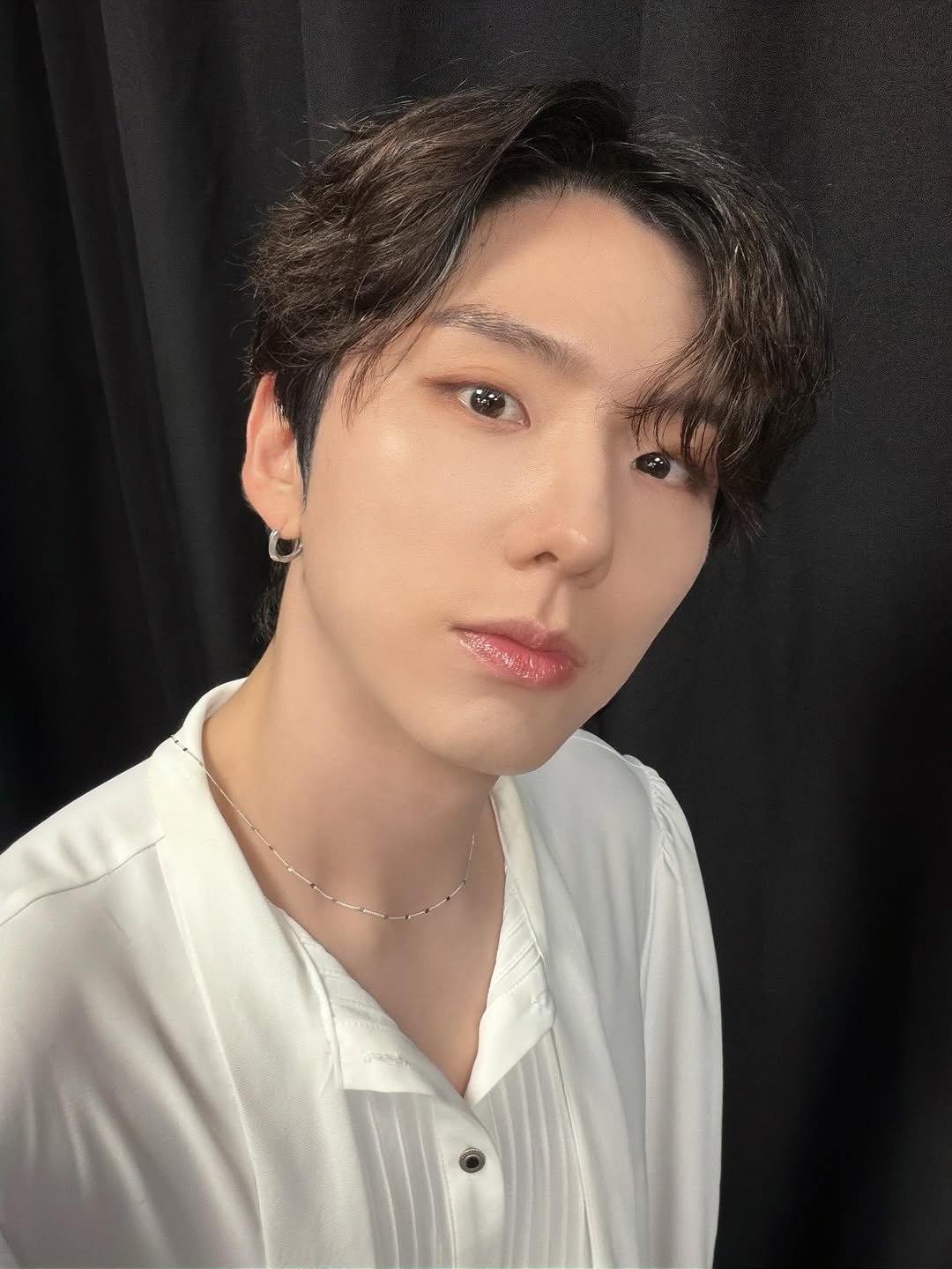 Photo by 기현 Kihyun on December 23, 2025. May be an image of one or more people, bangs, bolo tie and text.