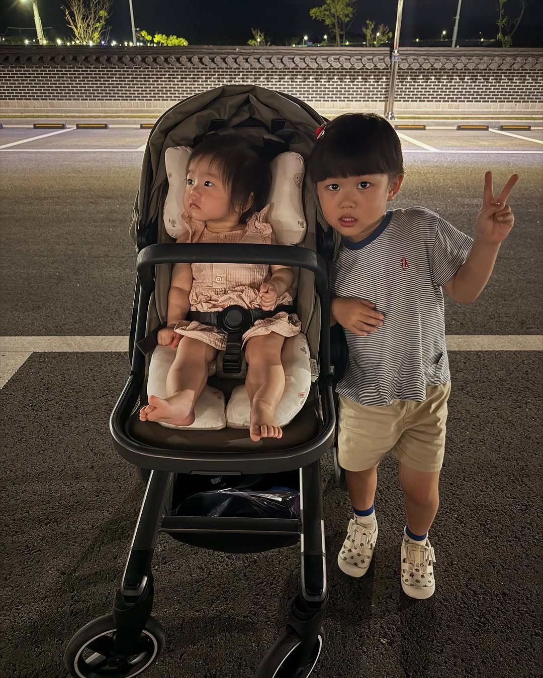 Photo by 유트루 on July 08, 2025. May be an image of 2 people, baby, buggy, night and text.