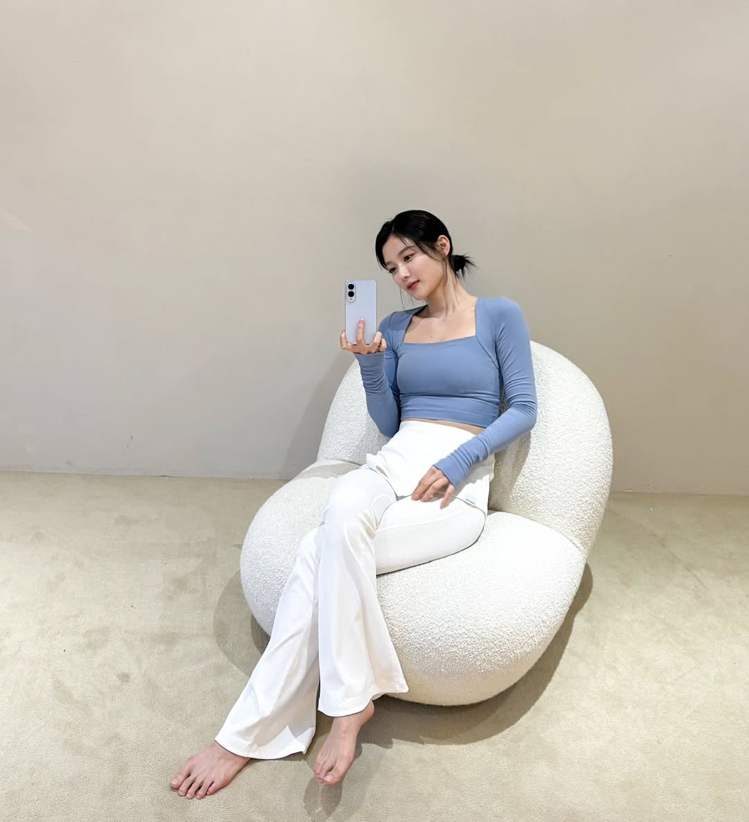 Photo shared by 김유정  KIM YOU JUNG 🇰🇷 on September 02, 2025 tagging @juvelook_official. May be an image of 1 person, phone, beanbag chair, deck chair, chaise lounge and text.