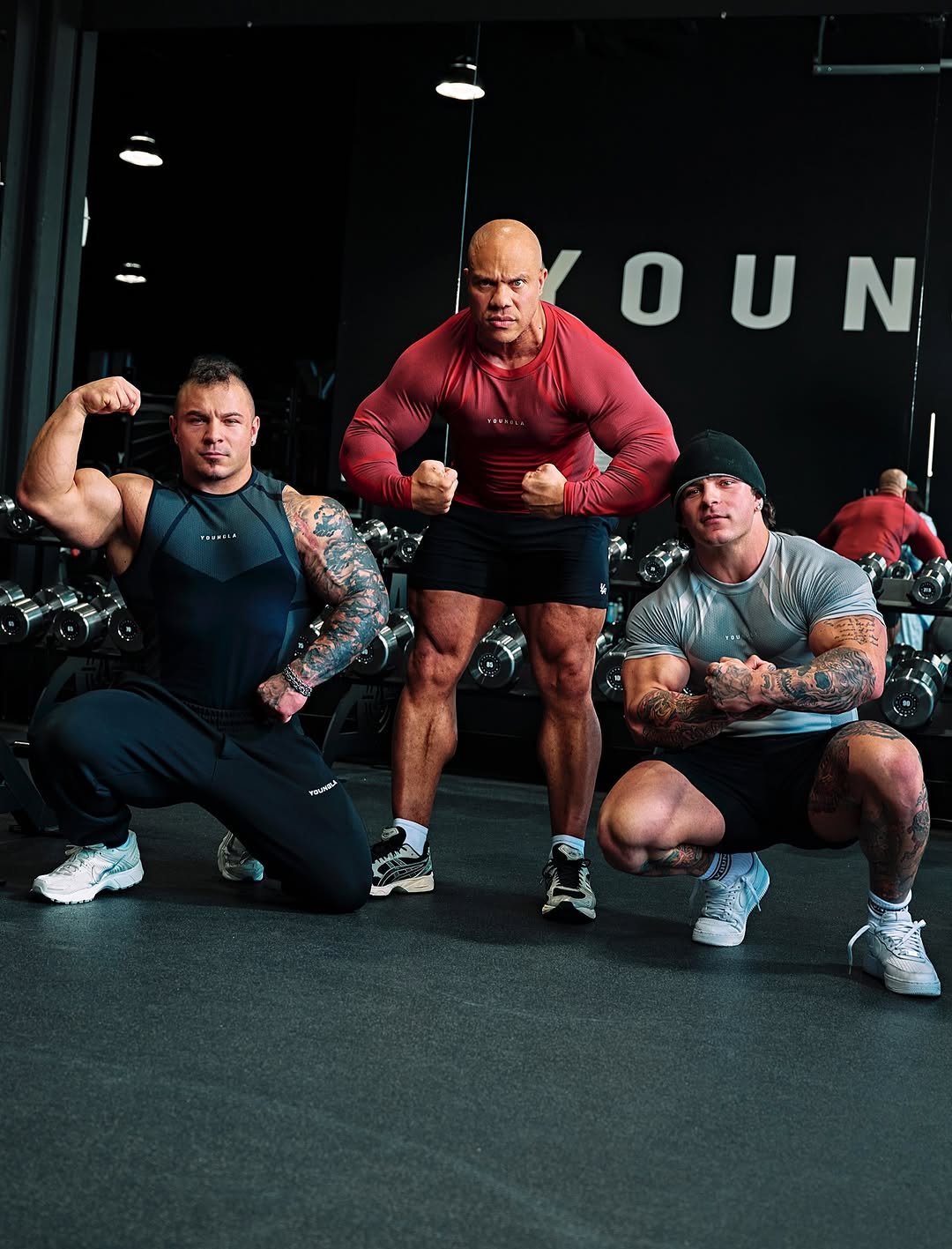 Photo shared by YoungLA on February 19, 2026 tagging @philheath, and @trentwinss_. May be an image of one or more people, biceps, people bodybuilding, activewear, sportswear, barbell and text.