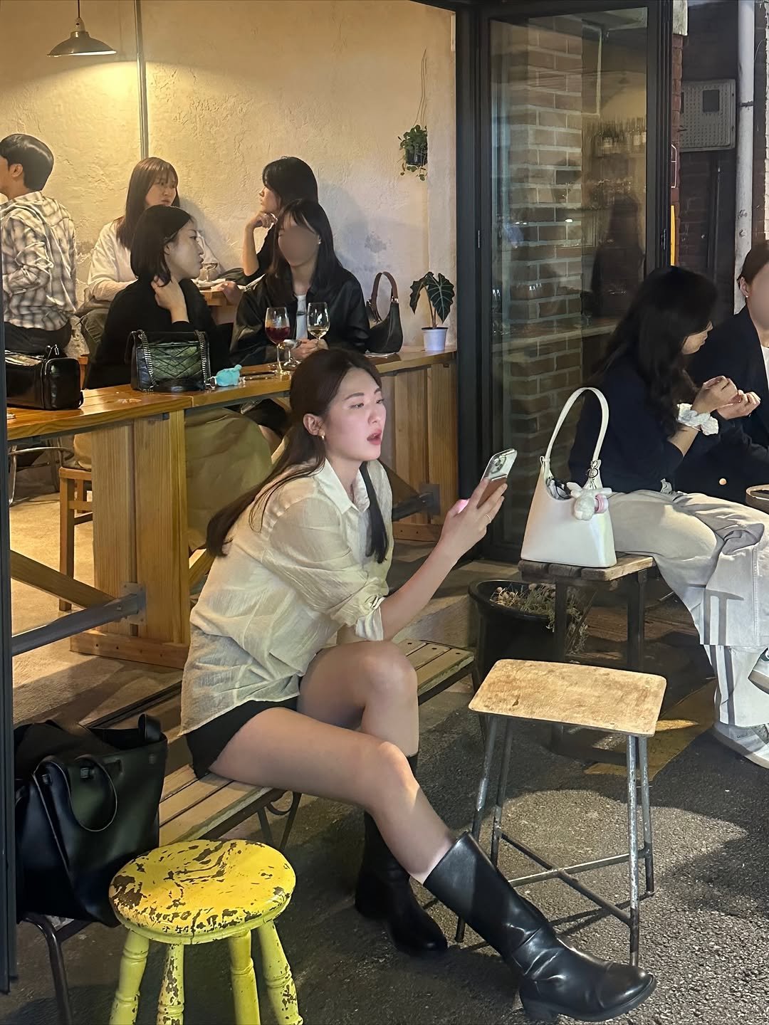 Photo by 윤수빈 (유어셀린) on November 09, 2025. May be an image of one or more people, hair, cornflower, brick wall and text.