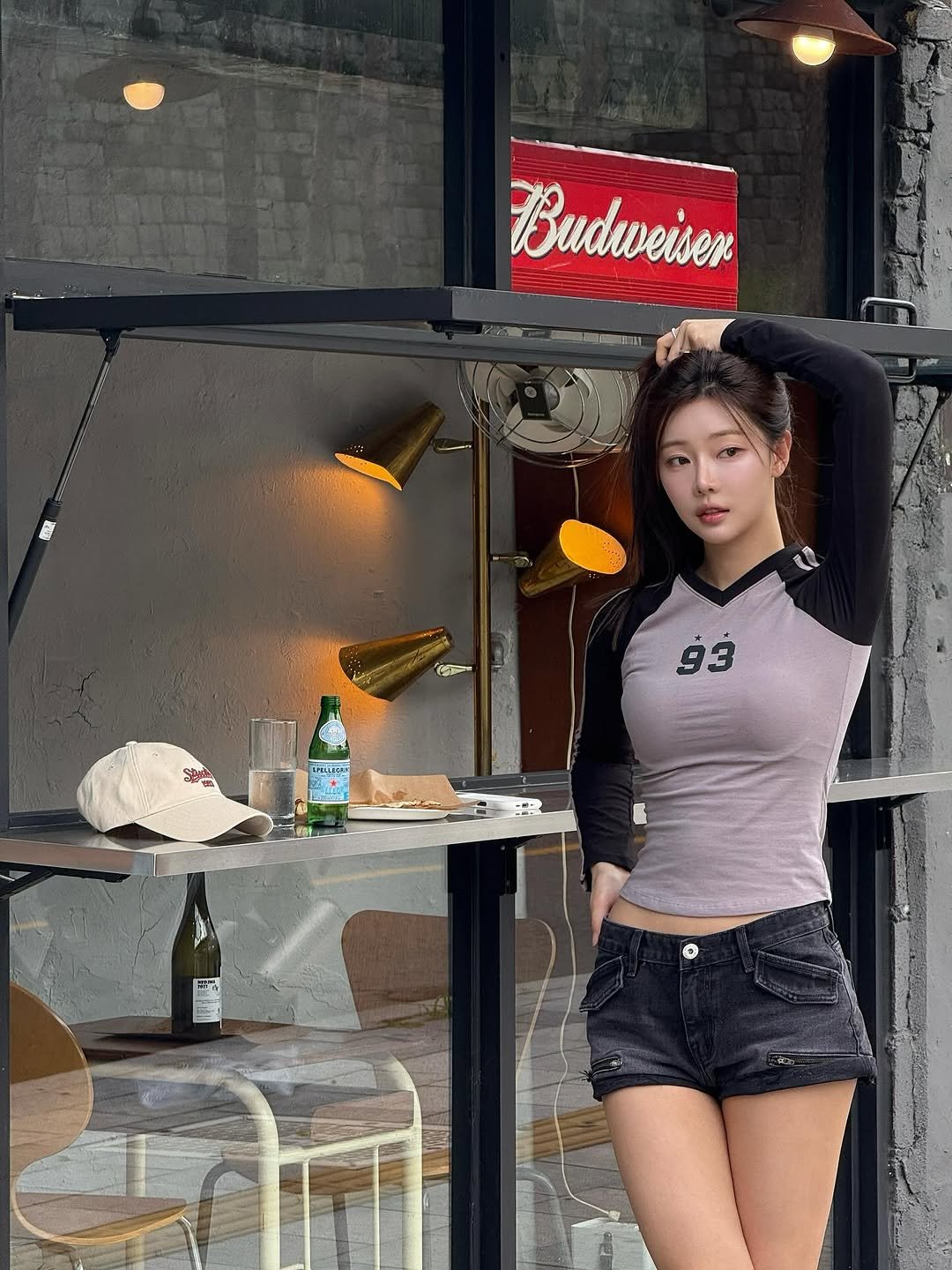 Photo shared by 이시안  ʟᴇᴇ sɪᴀɴ on September 25, 2025 tagging @1993studio_official. May be an image of 1 person, cigarette, top, shorts, beer bottle, miniskirt and text.