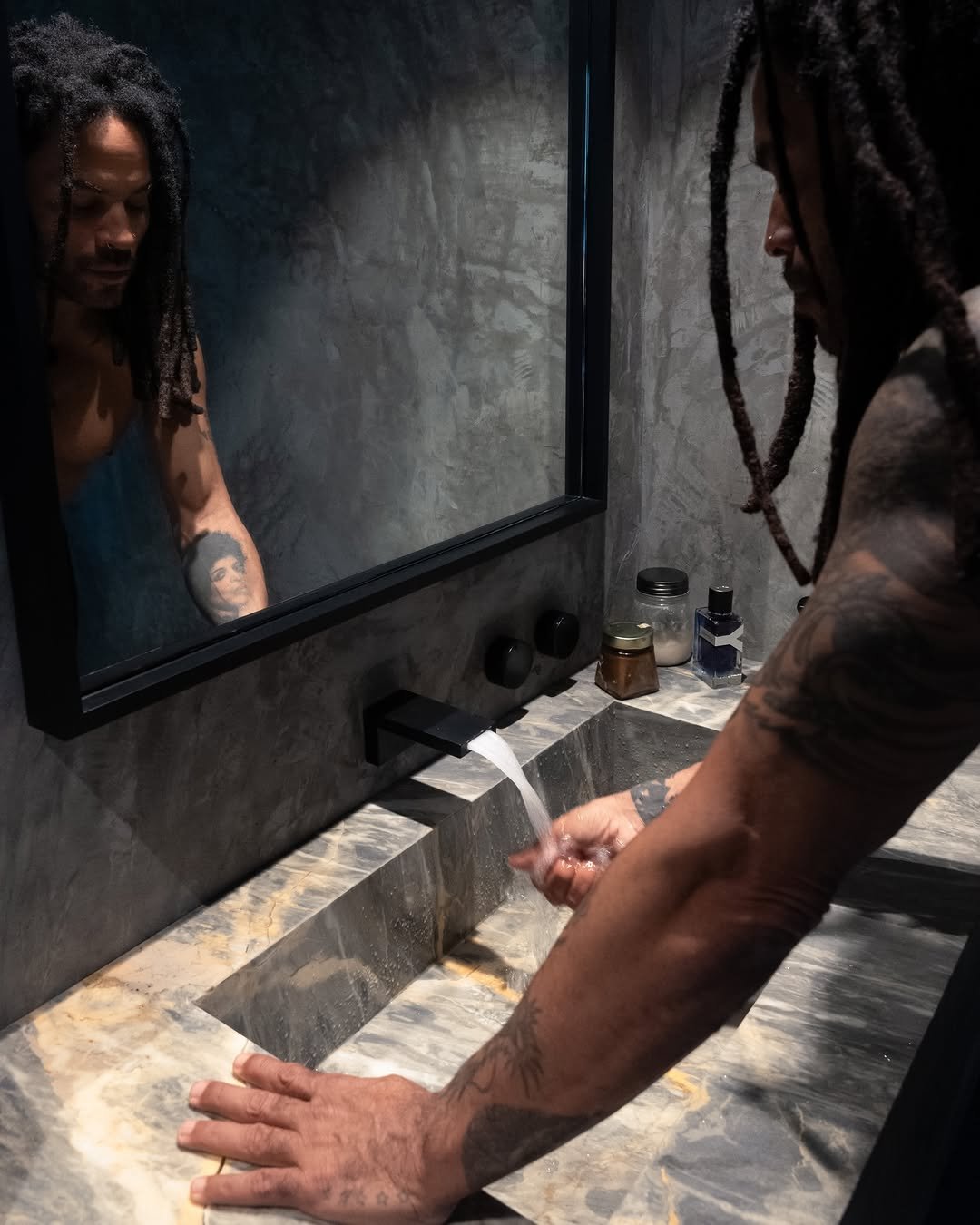 Photo shared by YSL Beauty Official on April 27, 2026 tagging @lennykravitz. May be an image of sink, shower, faucet, mirror, bathtub, wash basin, body of water and text.