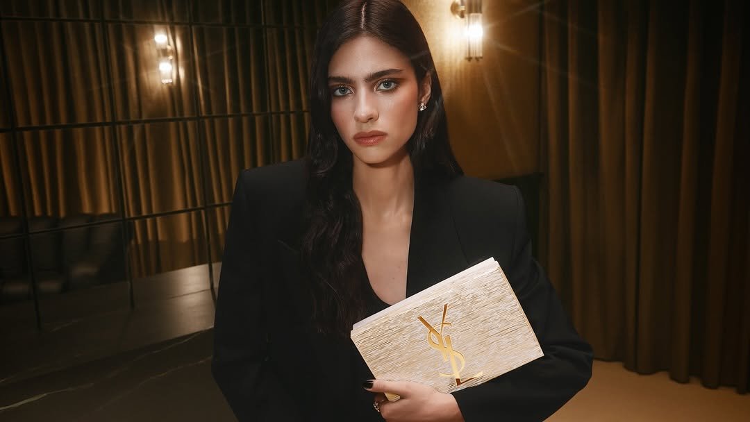 Photo by YSL Beauty Official on November 13, 2025. May be an image of one or more people, makeup, purse, clutch and text.