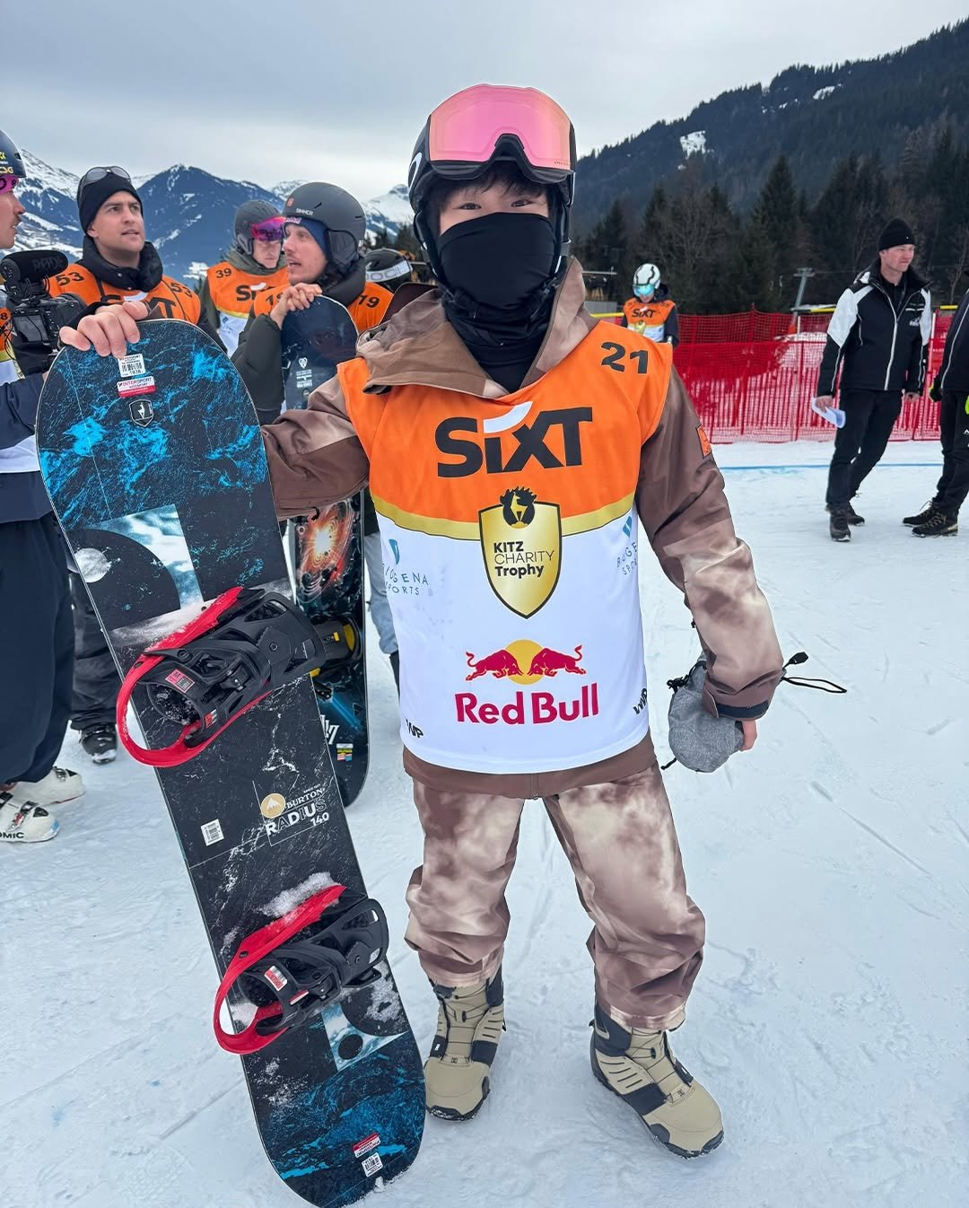 Photo shared by Yuki Tsunoda on January 26, 2026 tagging @redbull. May be an image of snowboarding, face mask, glasses, helmet, ski, snowsuit, ski slope and text that says 'ia 주도근 21 SIXT KHARITY KITZ ITY Trophy SENA FONTS ነጅ AME Red RedBull Bull 740 造'.