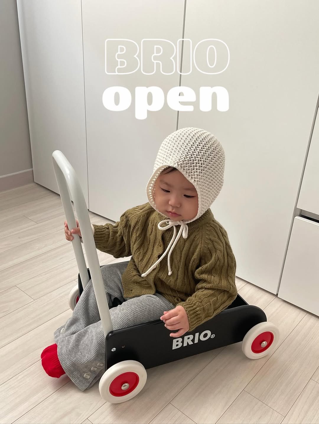 Photo by 하람맘 on November 16, 2025. May be an image of baby, duffle coat, hat and text that says 'BRIO open BRIO® ®'.