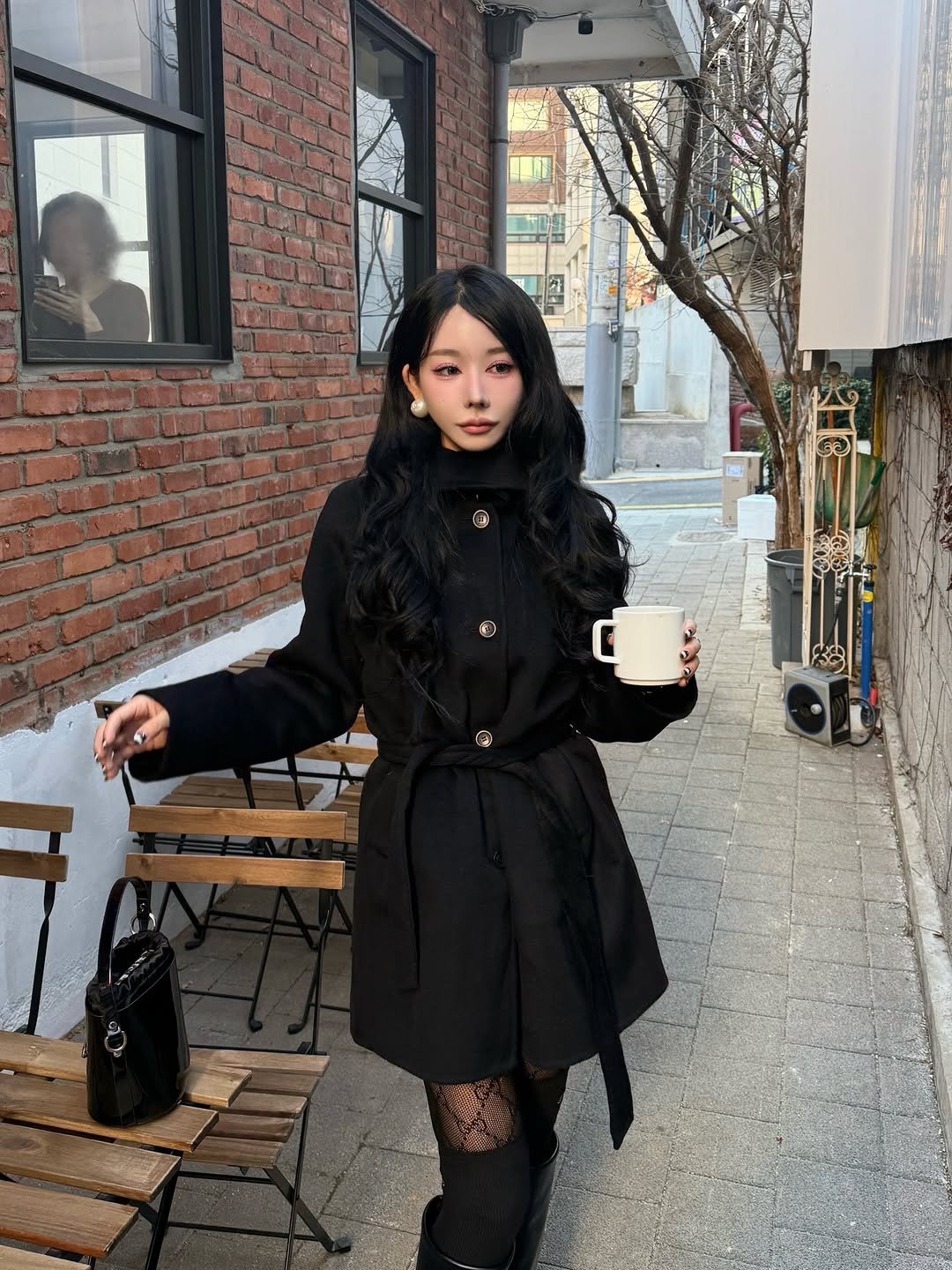 Photo shared by 유라 (李유라) on January 11, 2026 tagging @roem_official. May be an image of duffle coat, overcoat, turtleneck, parka, cornflower and text.