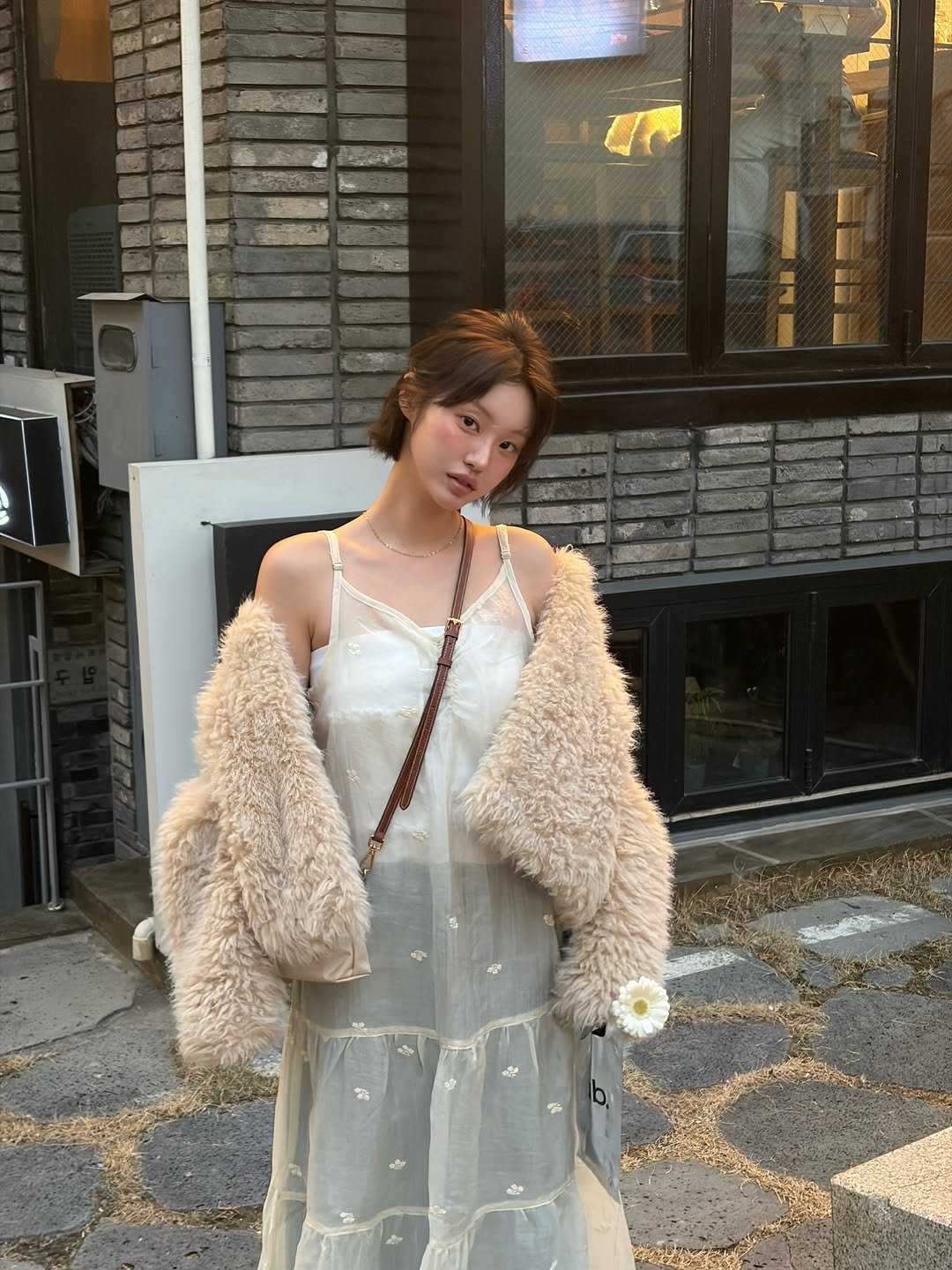 Photo shared by 하여니 on February 16, 2026 tagging @ournostalgia.kr. May be an image of overcoat, sable coat, goosedown coat, parka, dress and text.