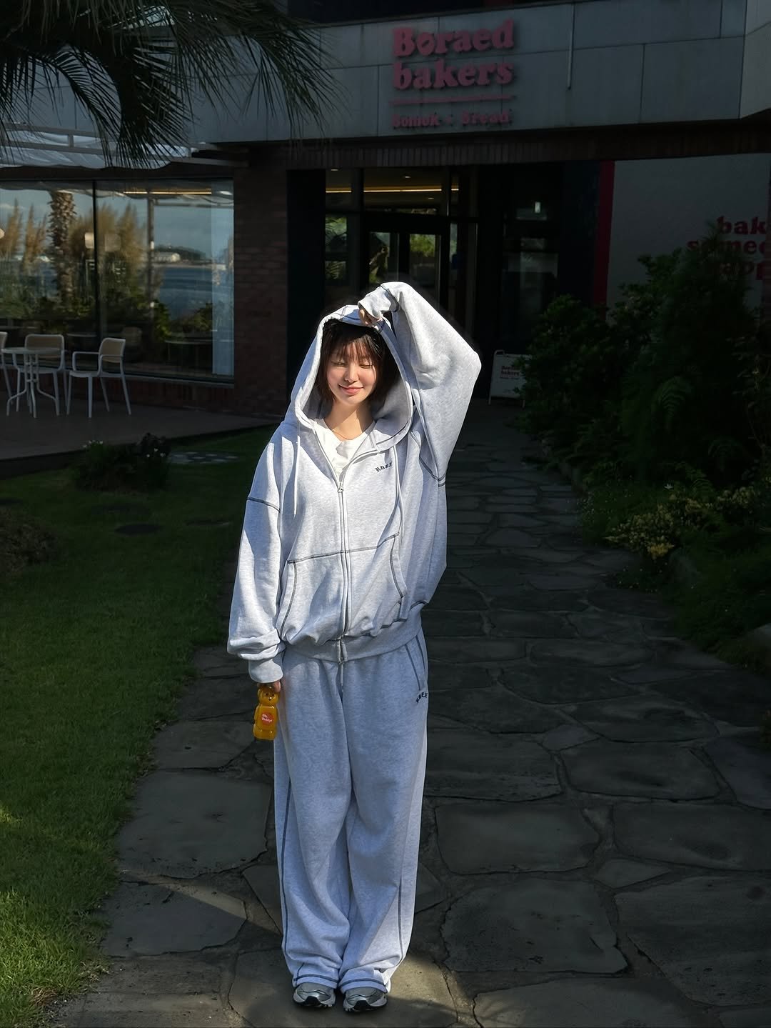 Photo shared by 하여니 on September 23, 2025 tagging @hdex__official. May be an image of 1 person, sleepwear, sweatsuit, parka, bath robe, sweatpants and text.
