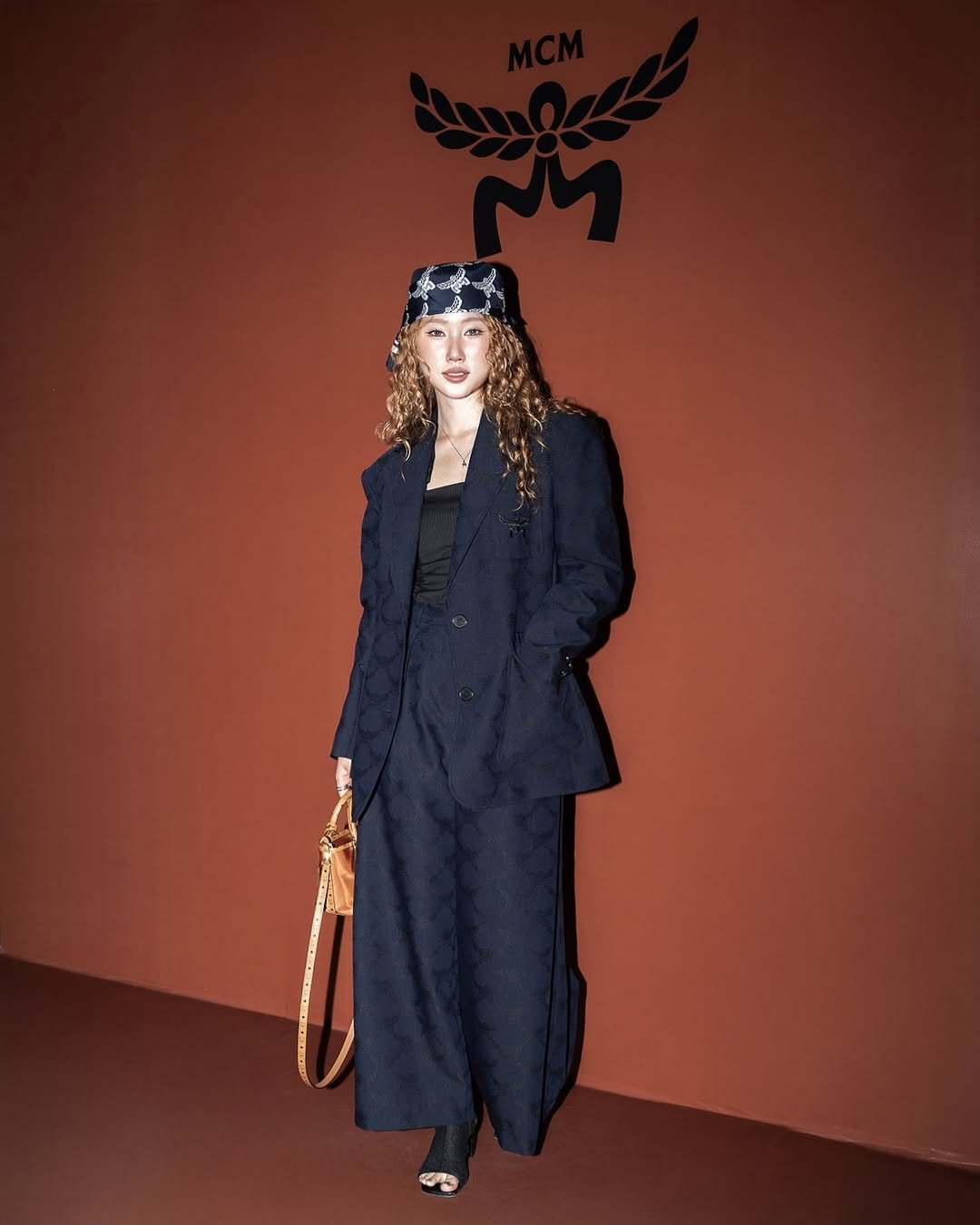 Photo shared by 연재중 on September 05, 2025 tagging @mcmworldwide. May be an image of beret and headscarf.