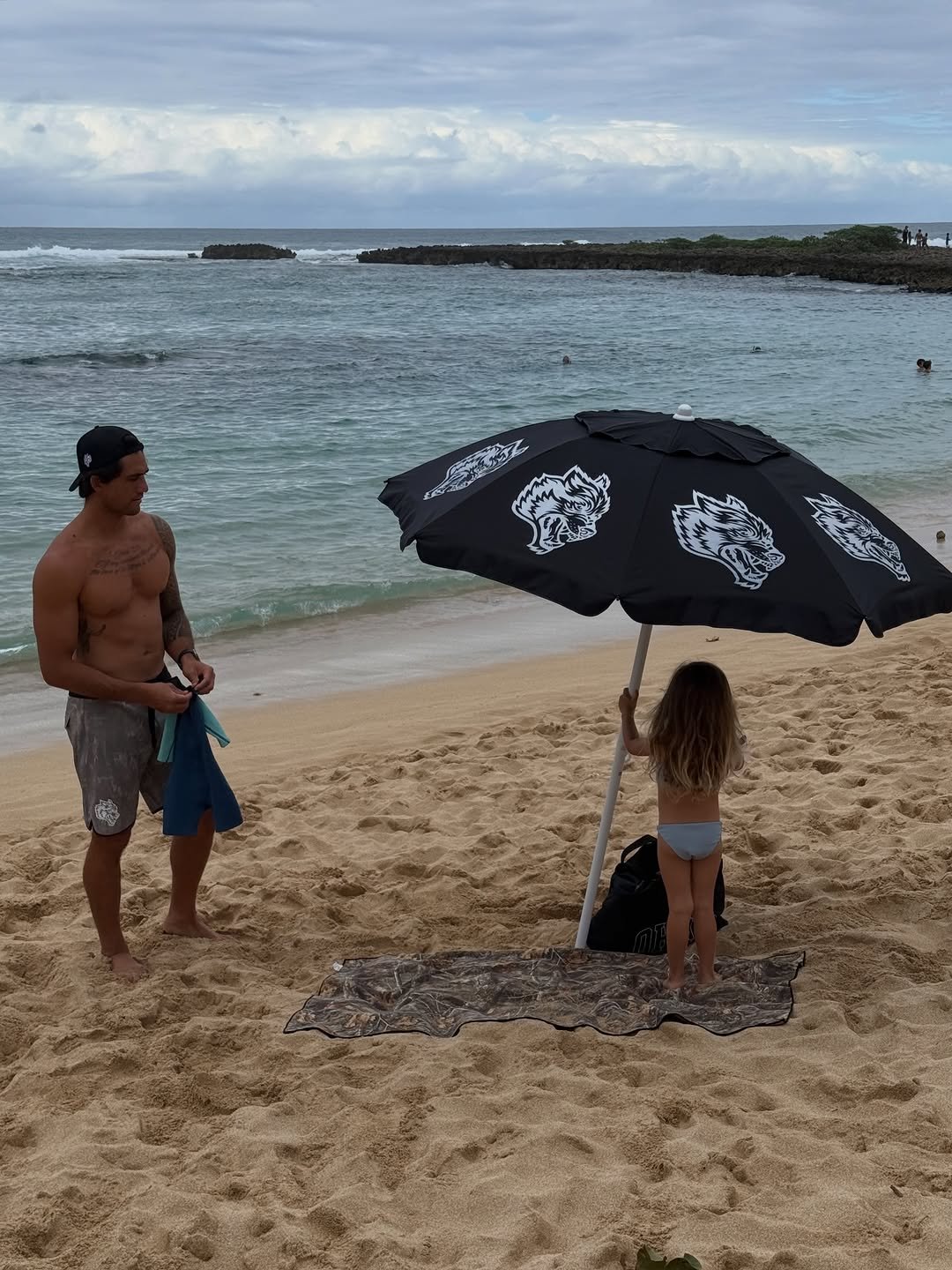 Photo by Zeke Lau on February 09, 2026. May be an image of parasol, umbrella, ocean, beach and text.