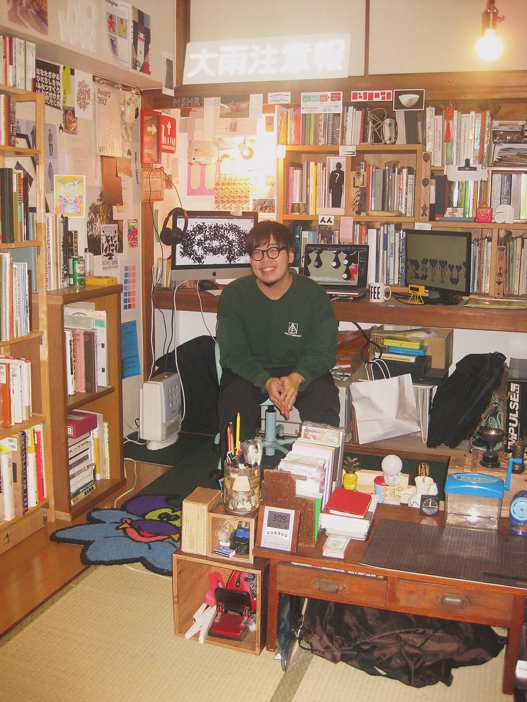 Photo by Zin Nagao on August 01, 2025. May be an image of 1 person, duffle coat, book, shelf and text.